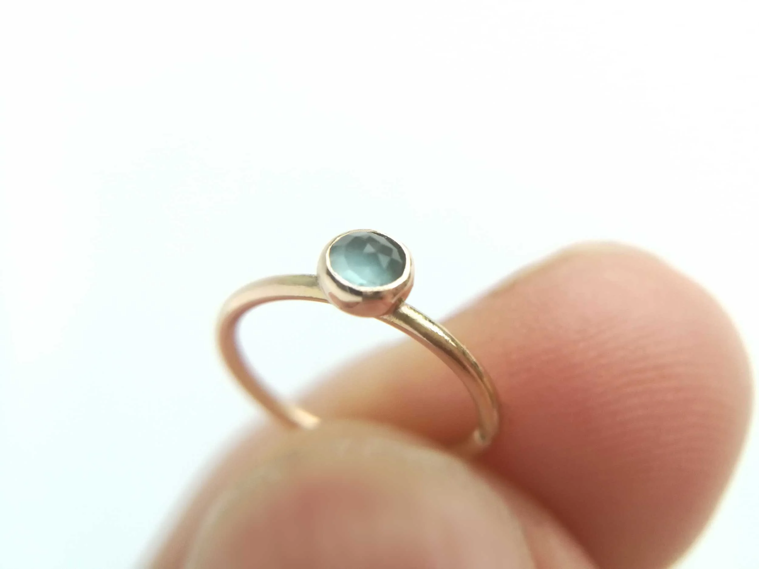 14k gold conch ring with blue topaz