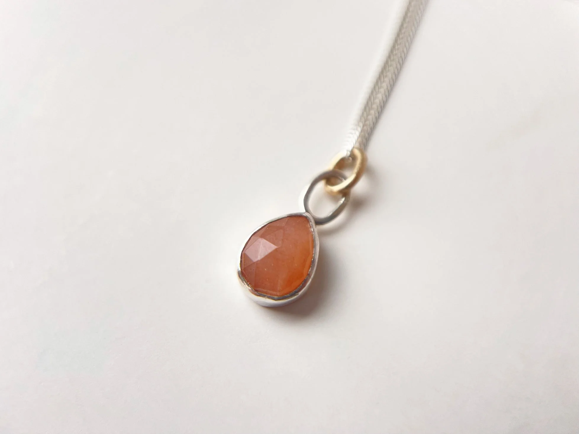peach moonstone teardrop pendant on white background