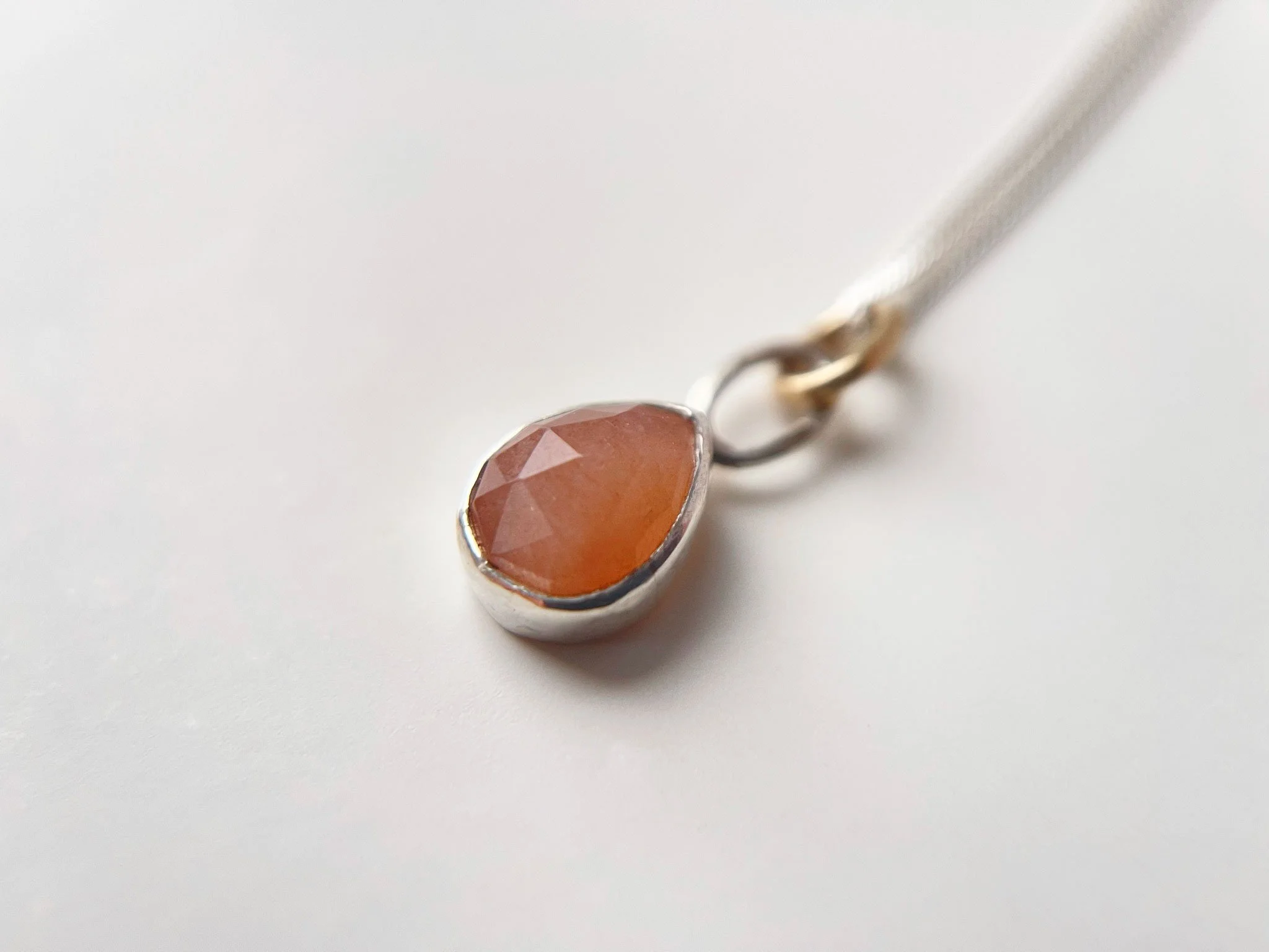 handmade peach moonstone necklace close up on chain