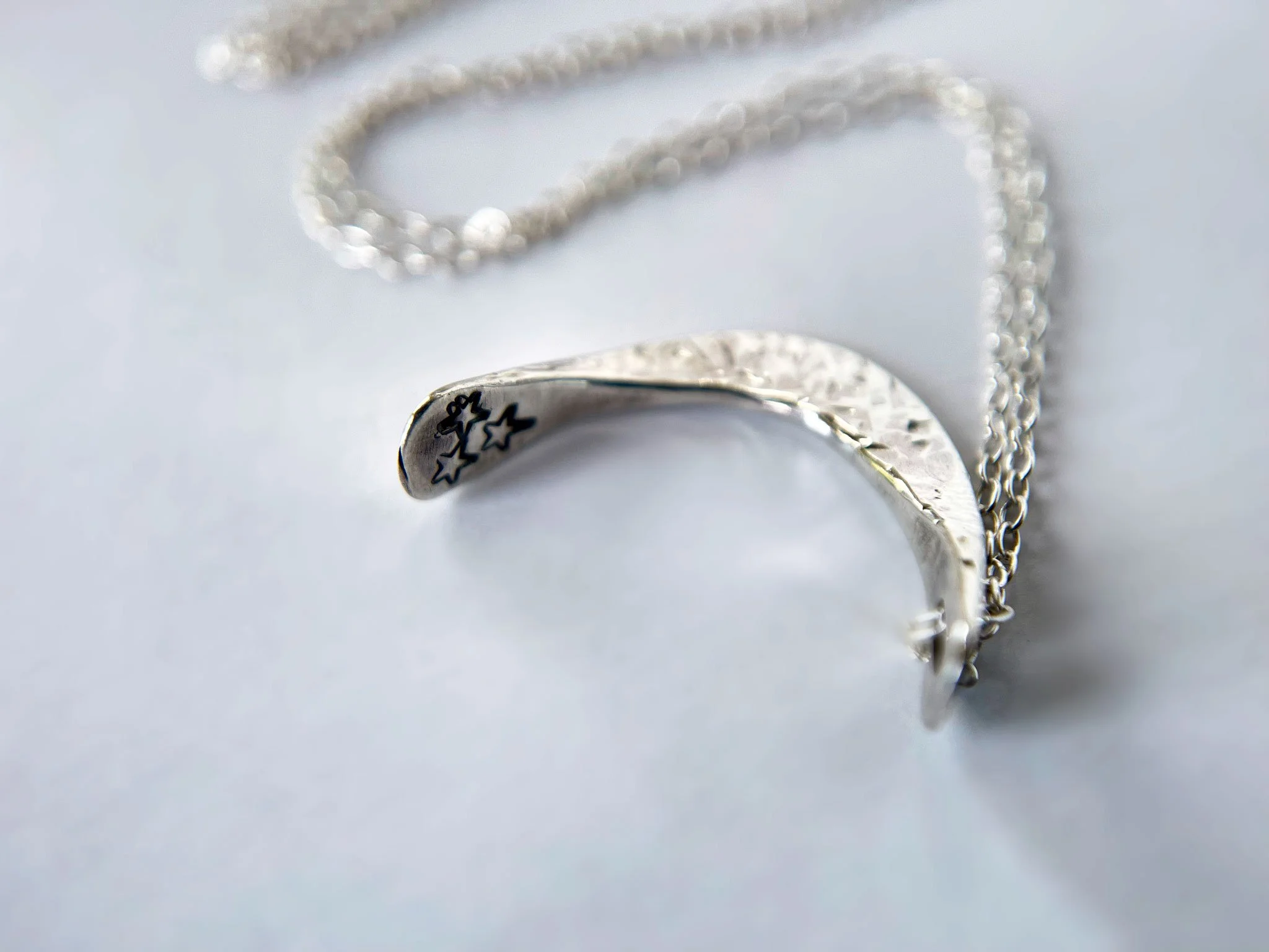 star stamped silver crescent moon necklace close up