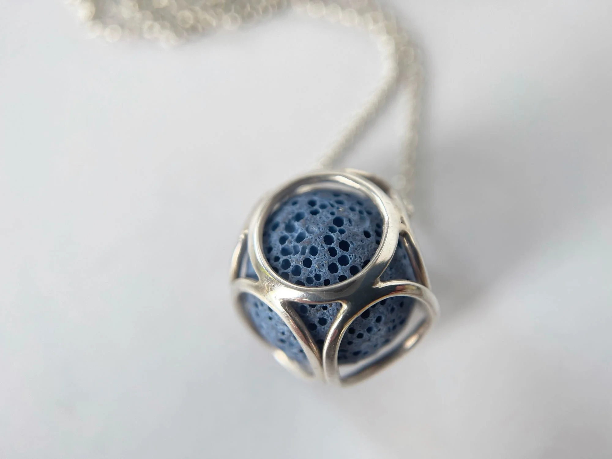 silver art deco style pendant with blue lava bead