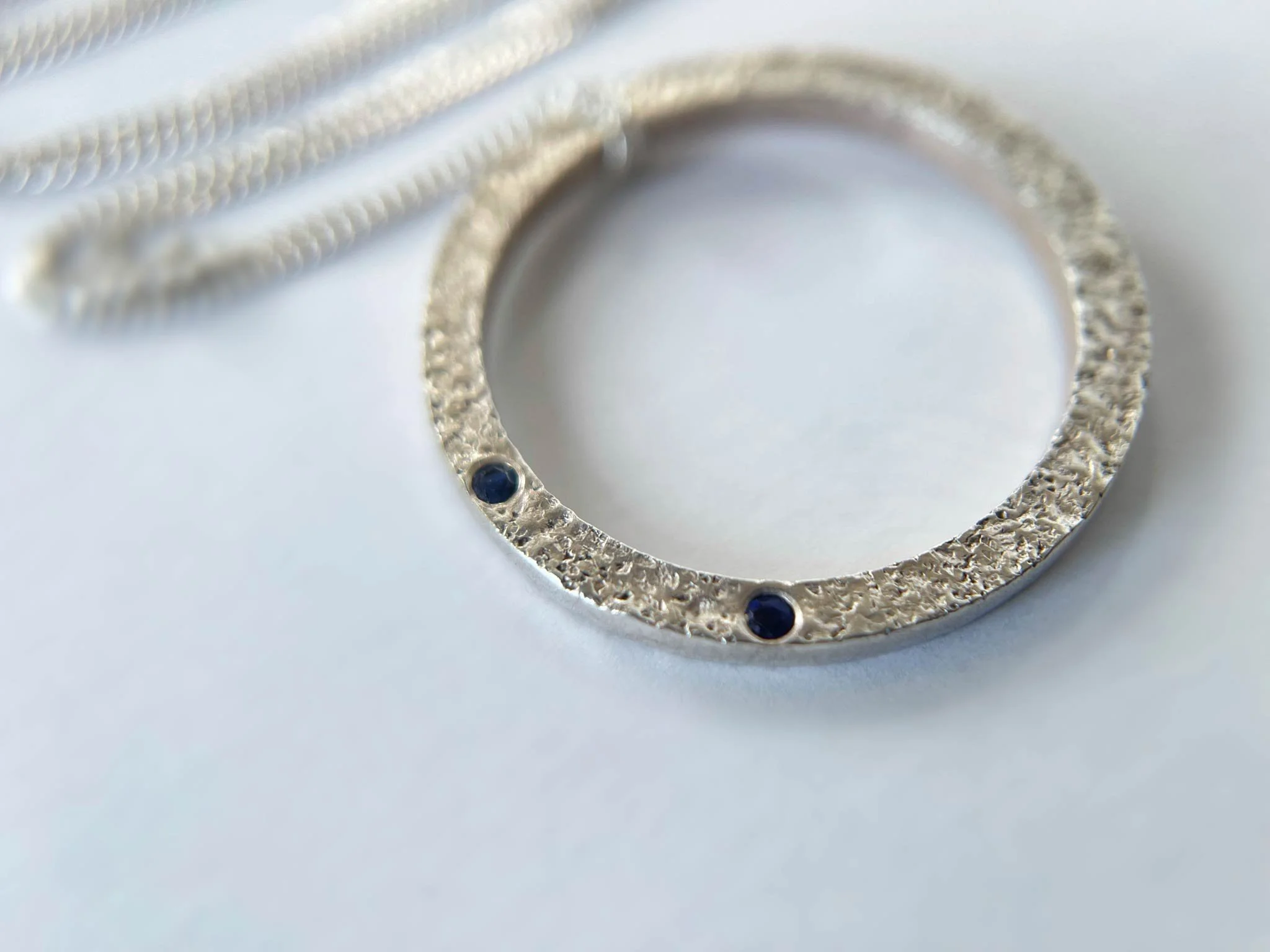 silver and sapphire handmade necklace close up