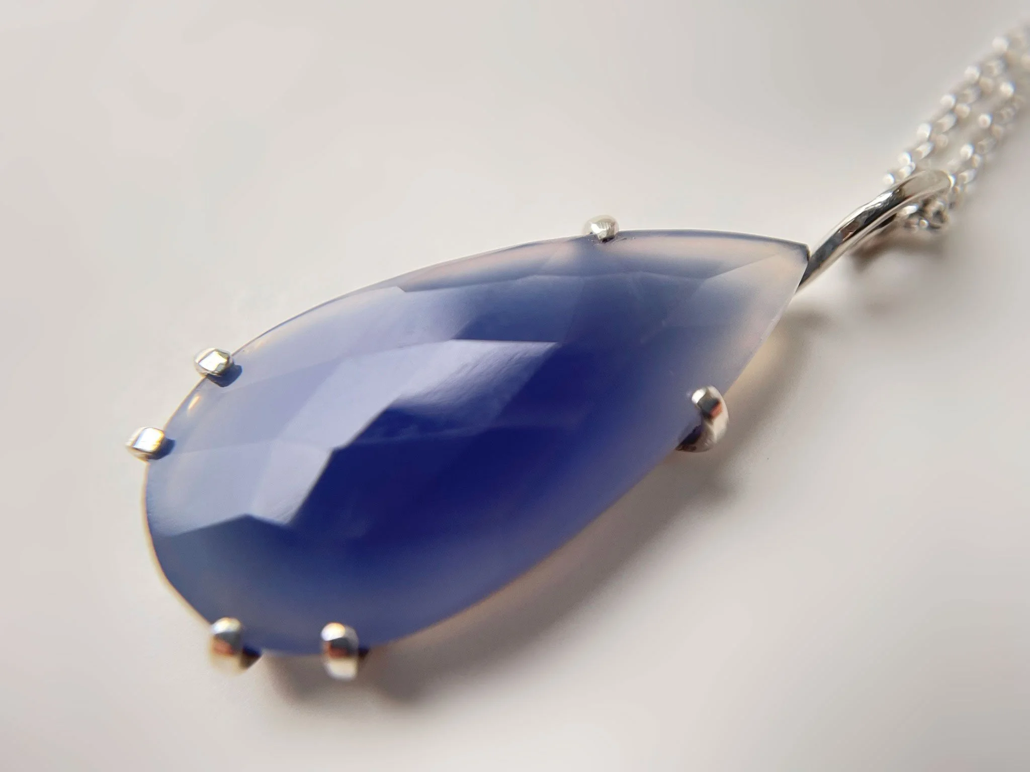 close up of handmade silver and blue chalcedony pendant