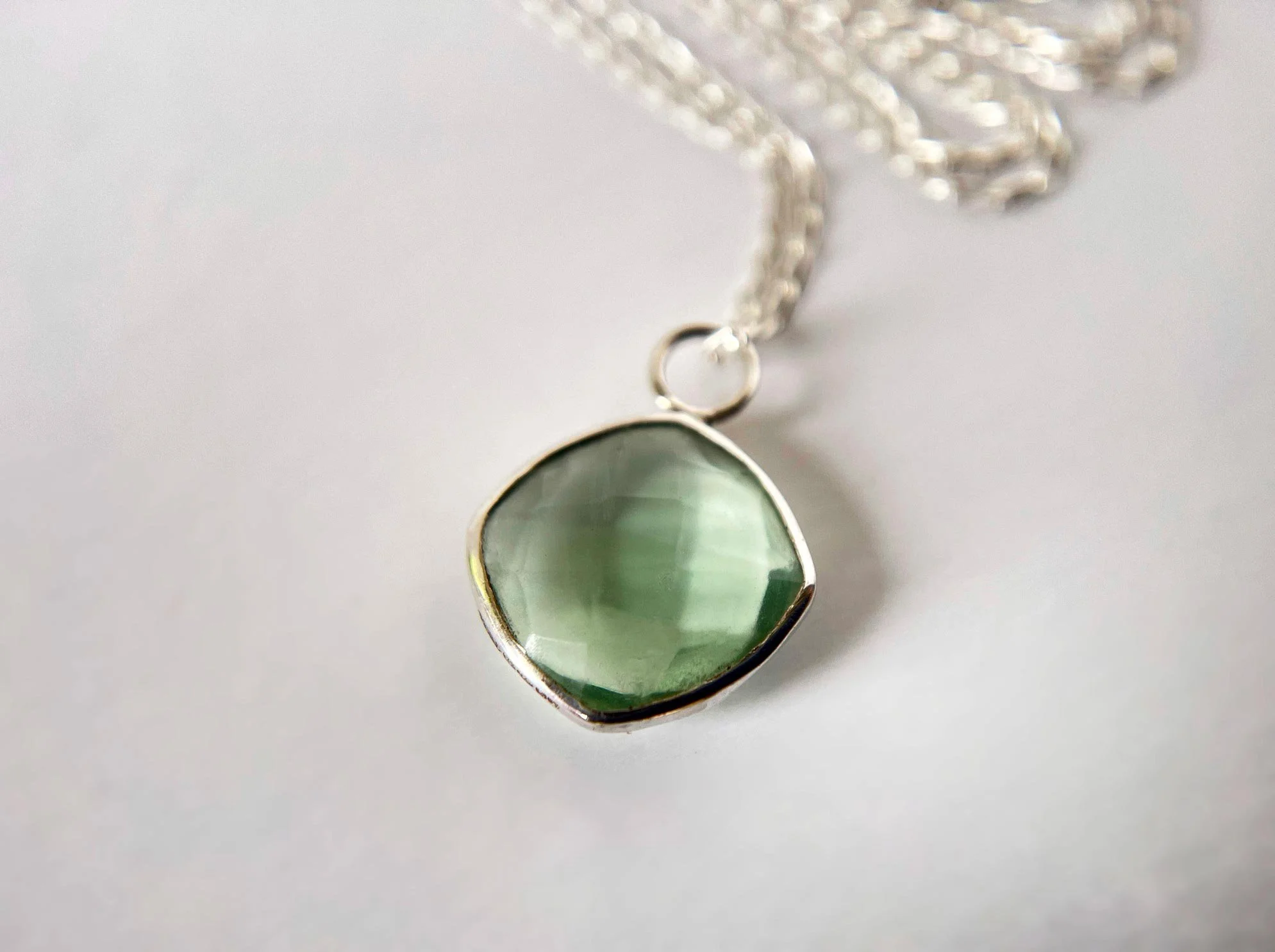 square green flourite pendant white background