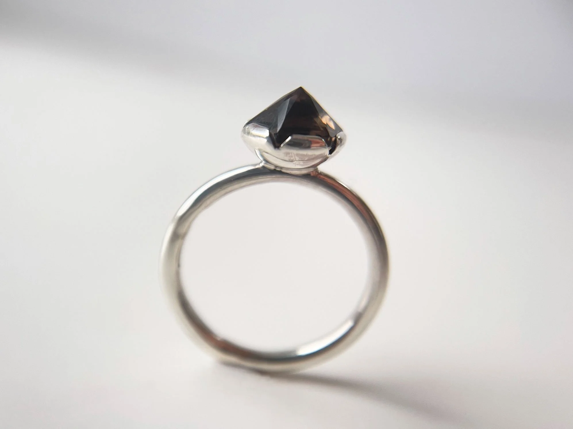 pyramid shape smoky quartz ring silver band white background