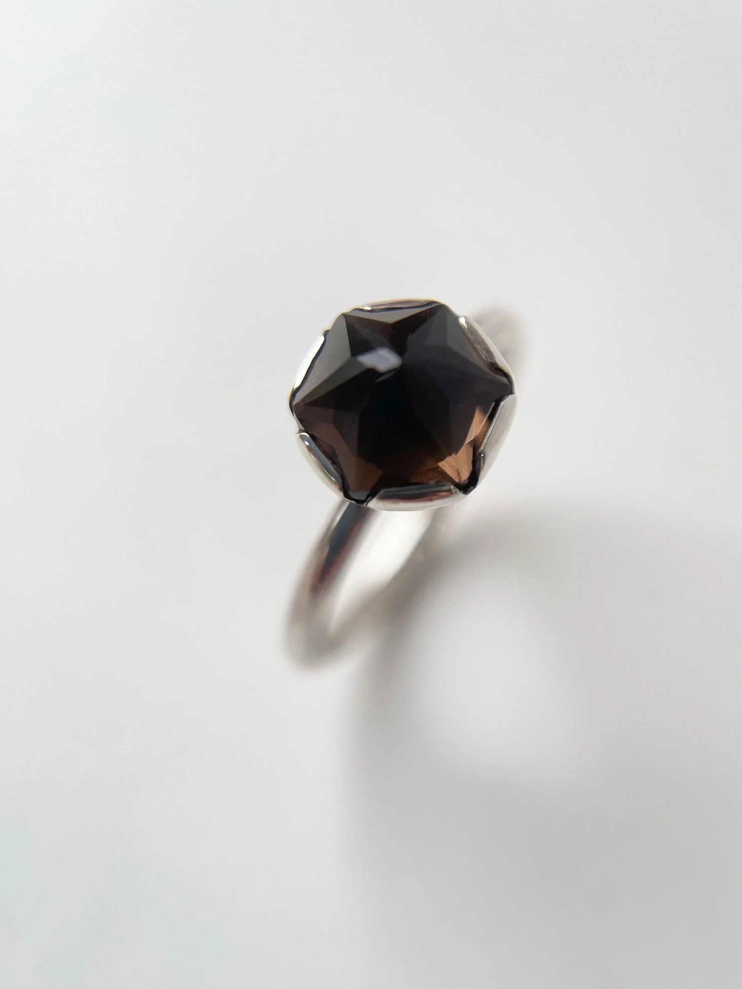 inverted faceted smoky quartz in one of a kind setting close up