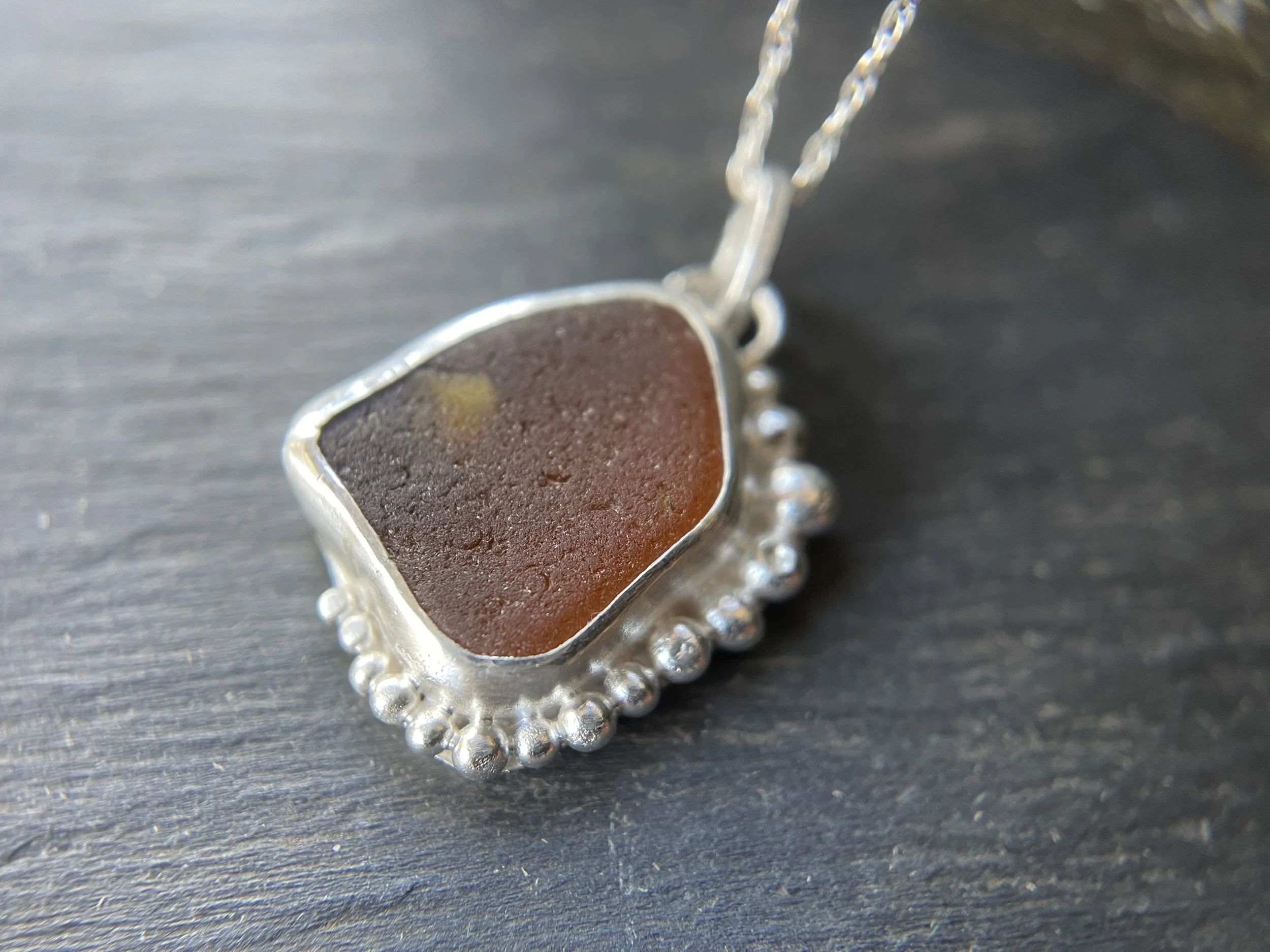 Handmade amber sea glass pendant close up