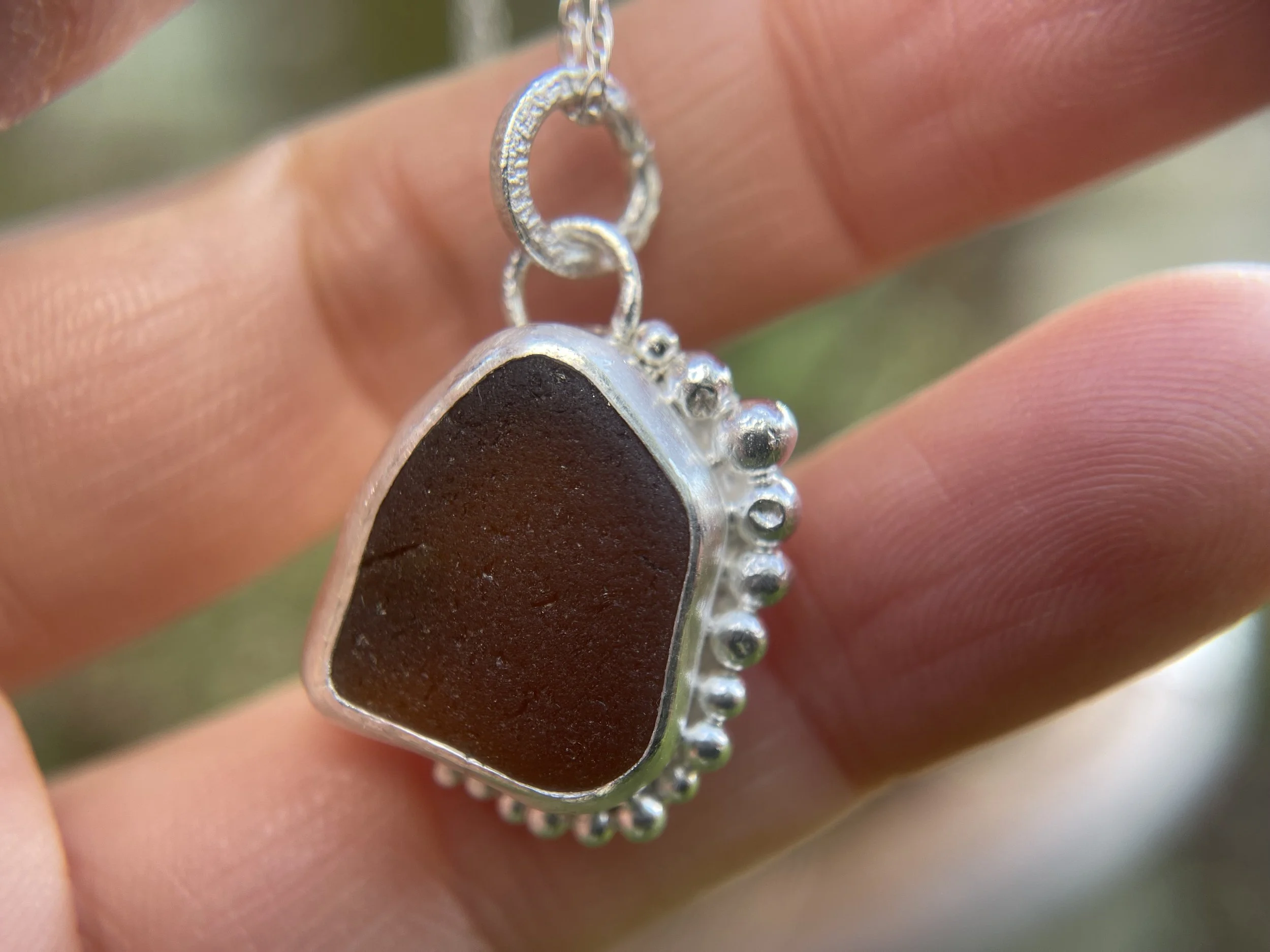 Natural sea glass pendant close up