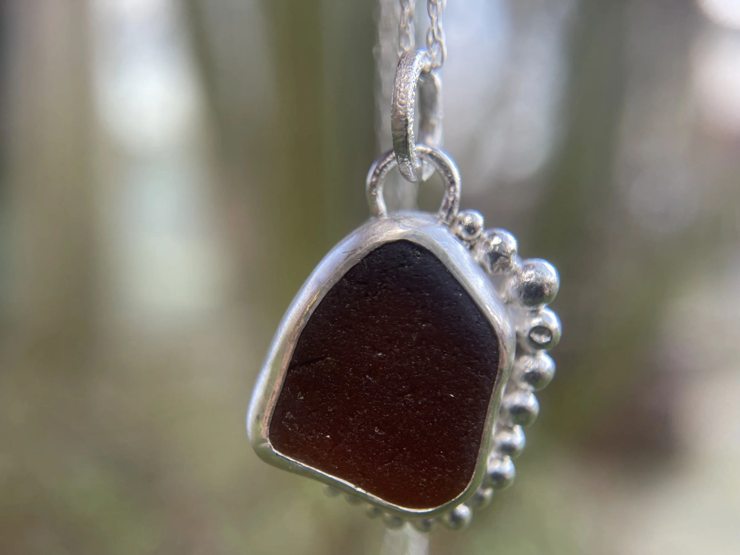 Natural amber sea glass necklace close up