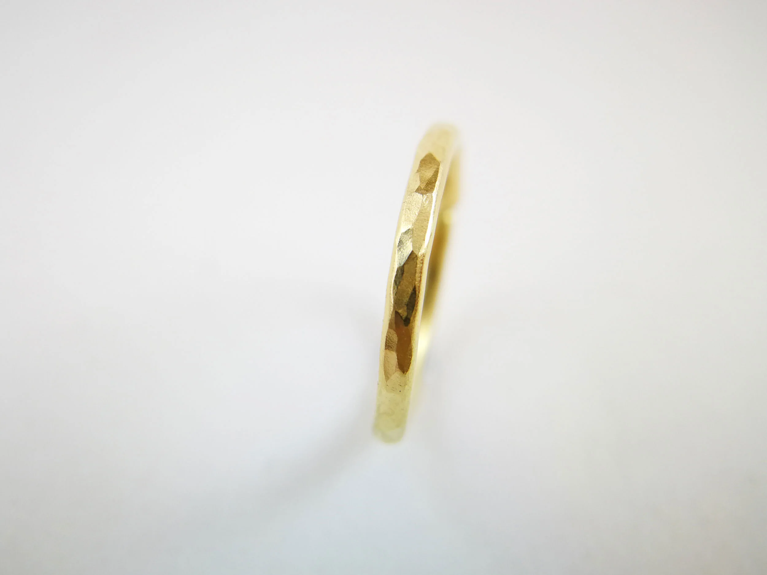 Hammered recyced 18 carat gold helix earring white background