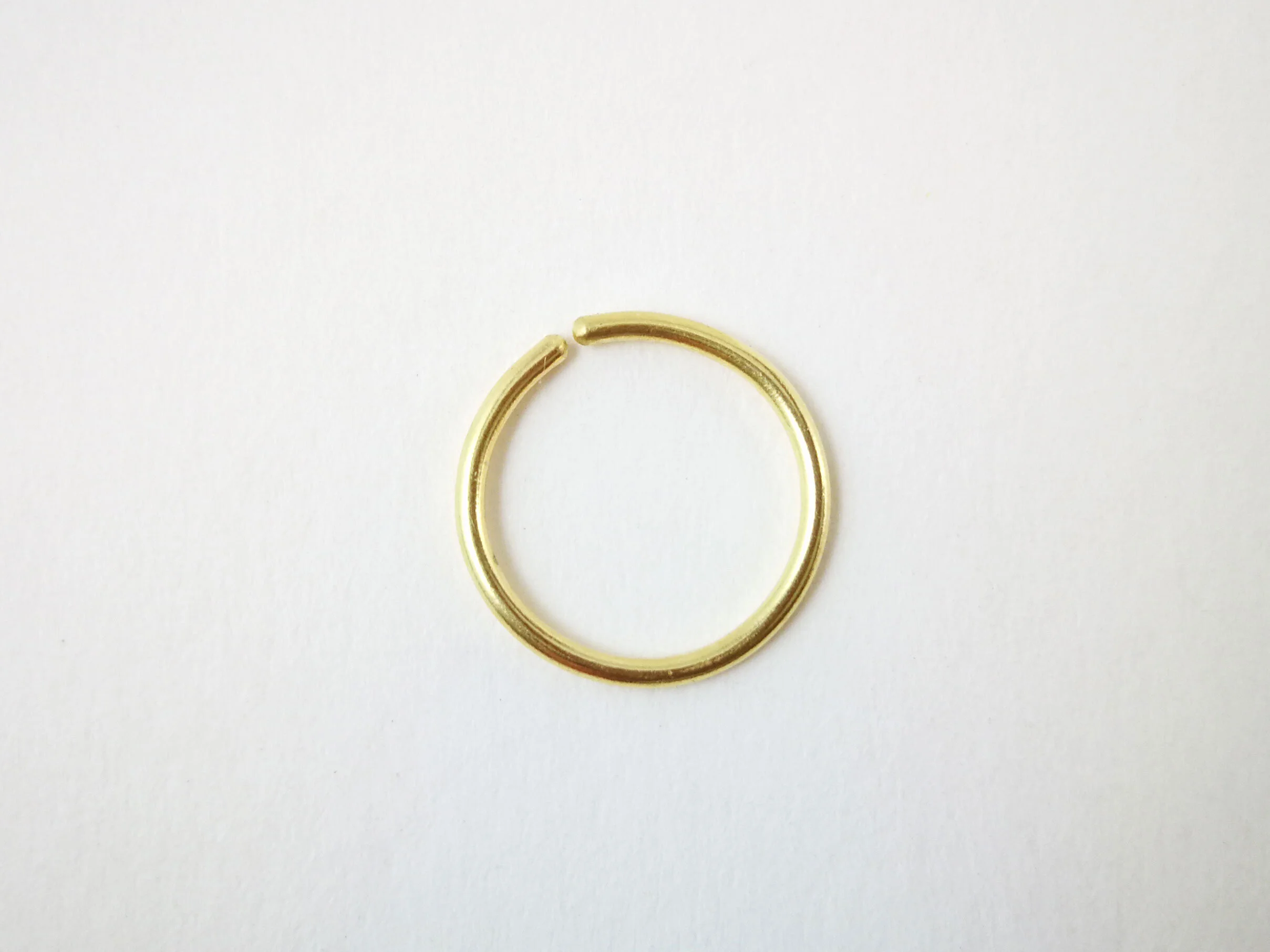 Smooth 18k gold cartilage hoop white background