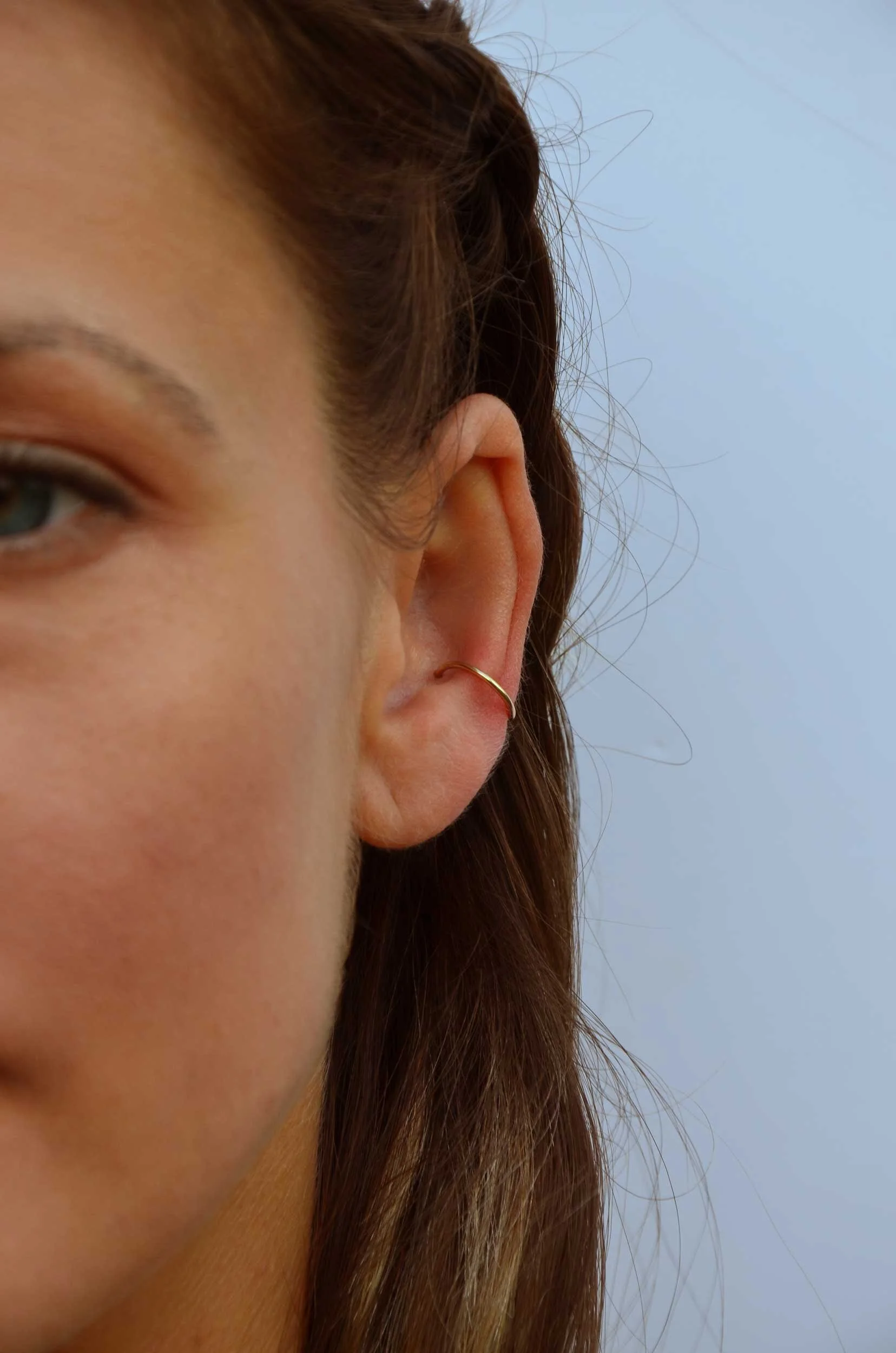 Solid 18k gold helix hoop on model victoria grace silversmith