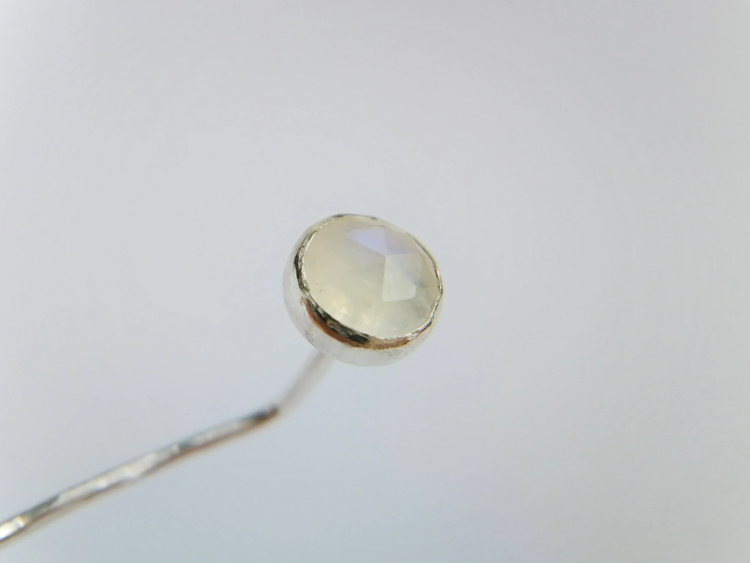 Faceted moonstone handmade earring close up white background