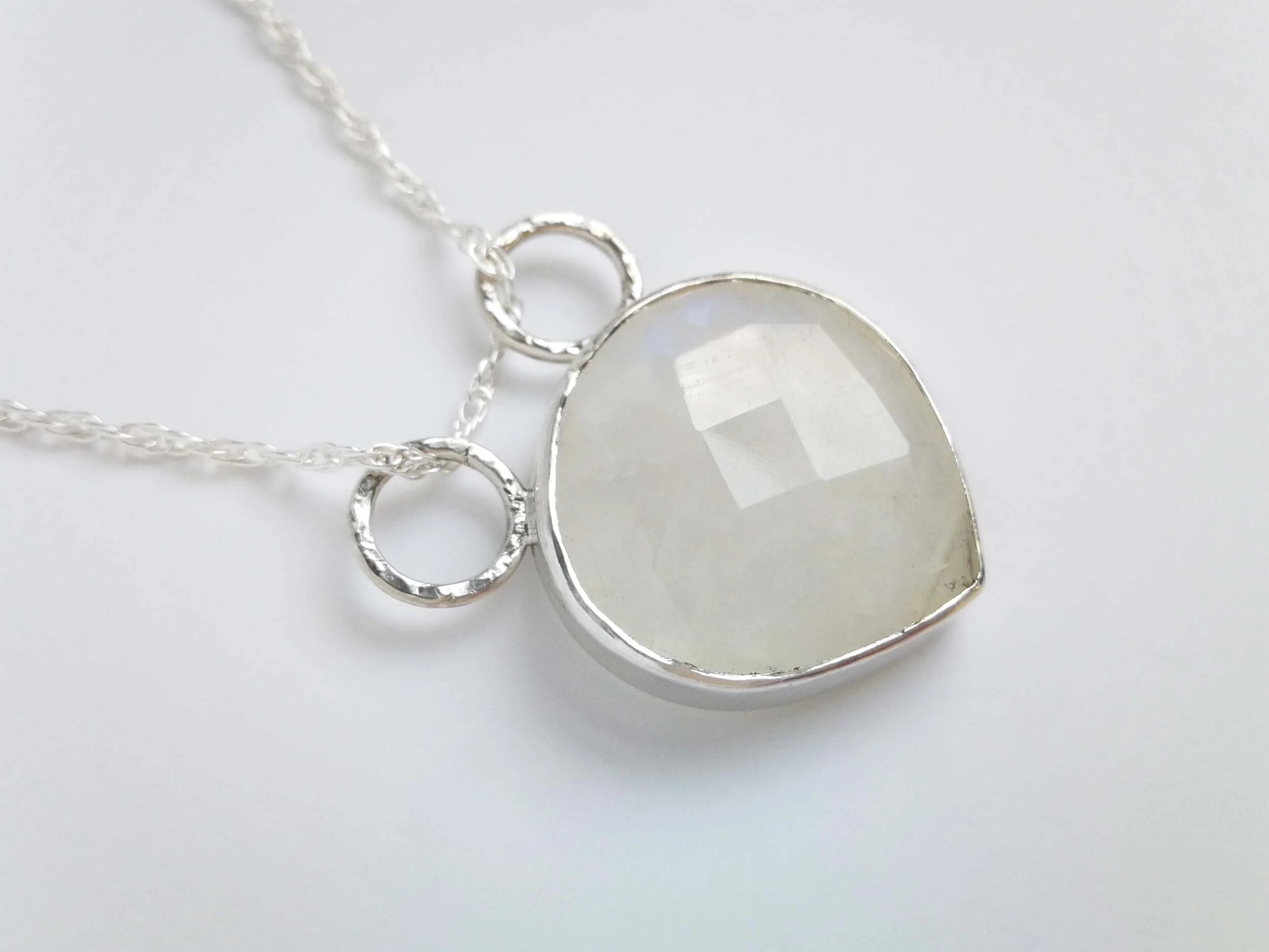Faceted rainbow moonstone pendant product photo white background
