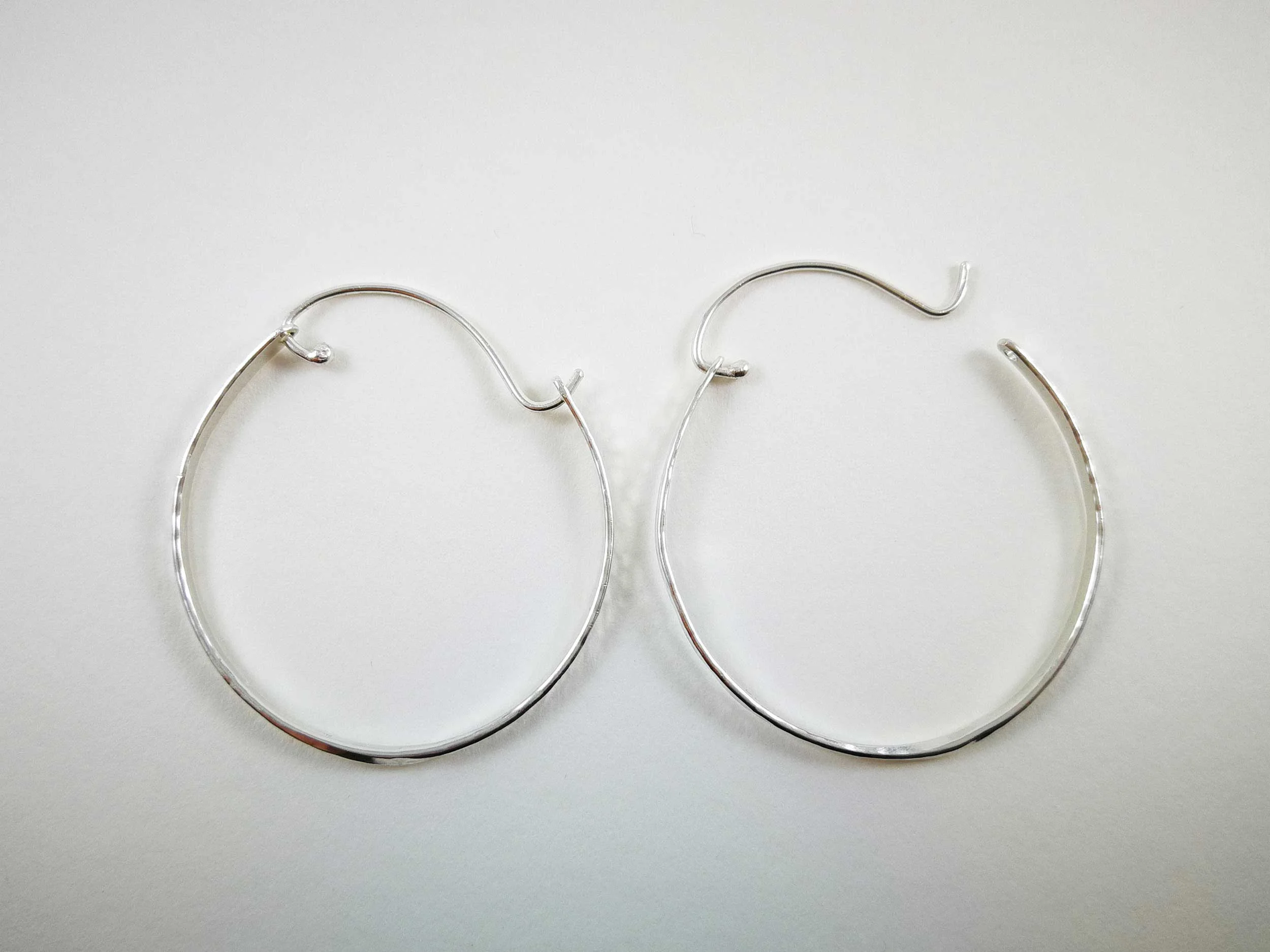 handmade silver hoop earrings white background