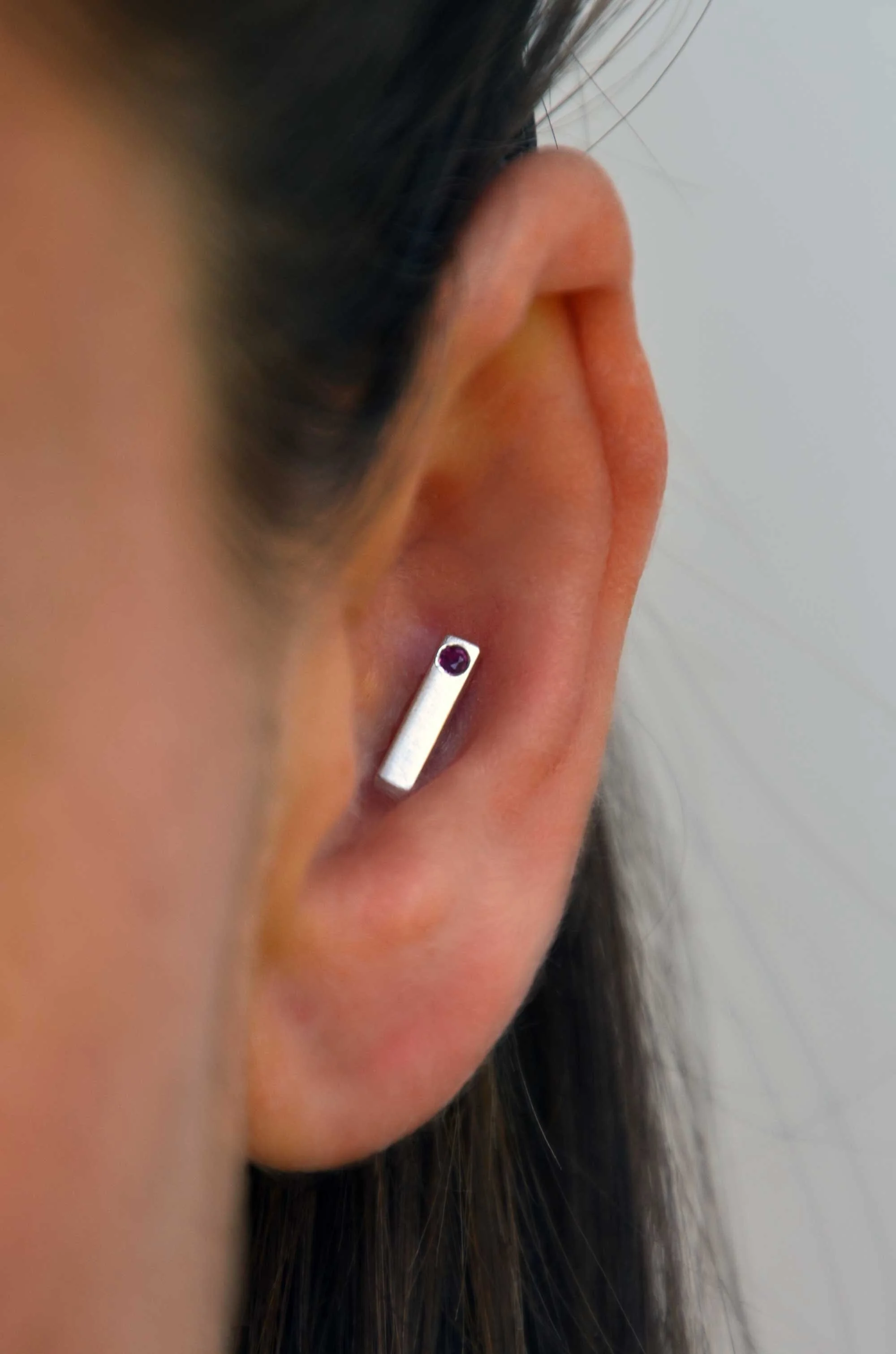 ruby and sterling silver conch earring on model handmade piercing jewellery