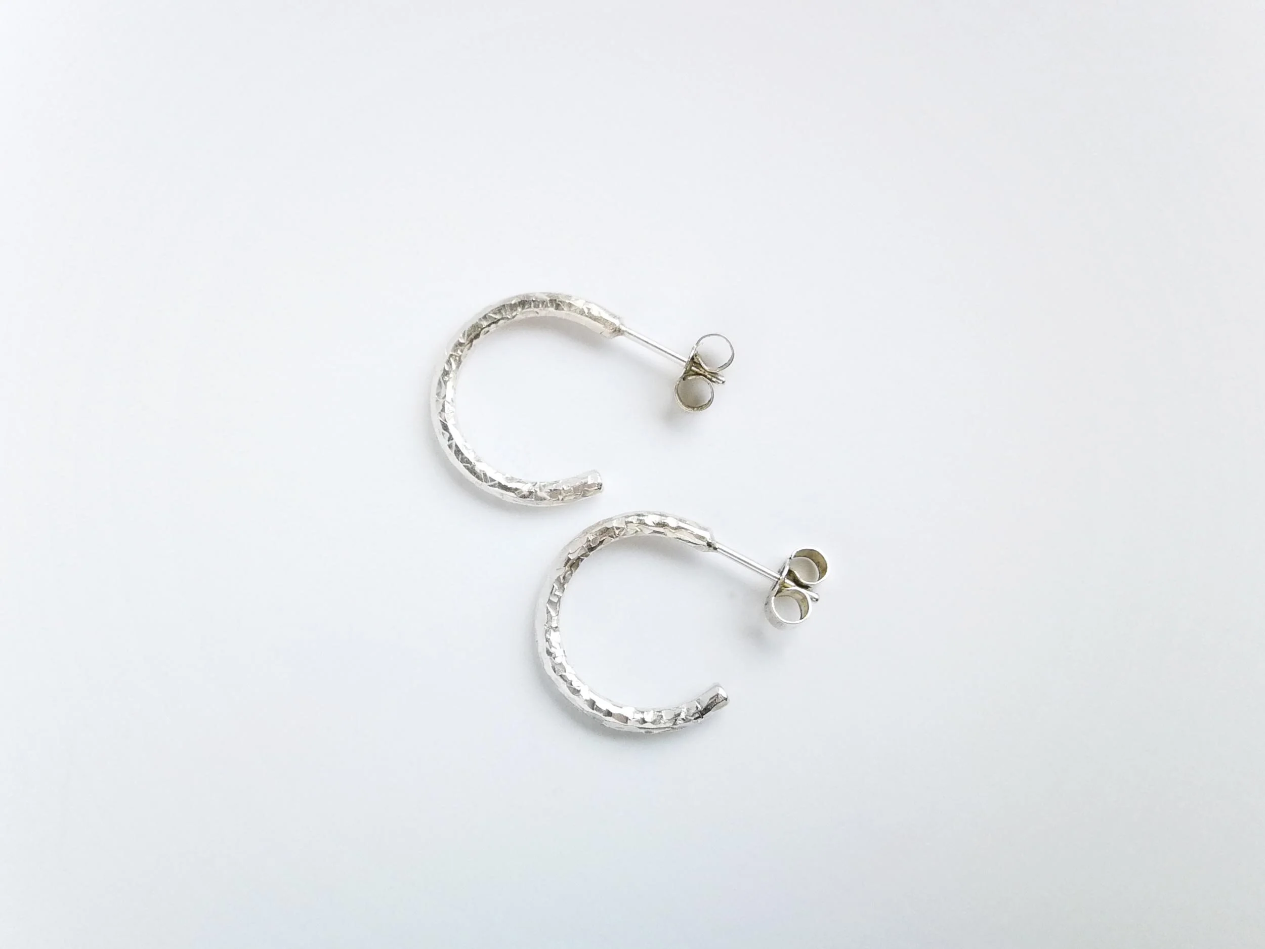 Sparkly textured hoop earrings handmade by victoria grace silversmith white background