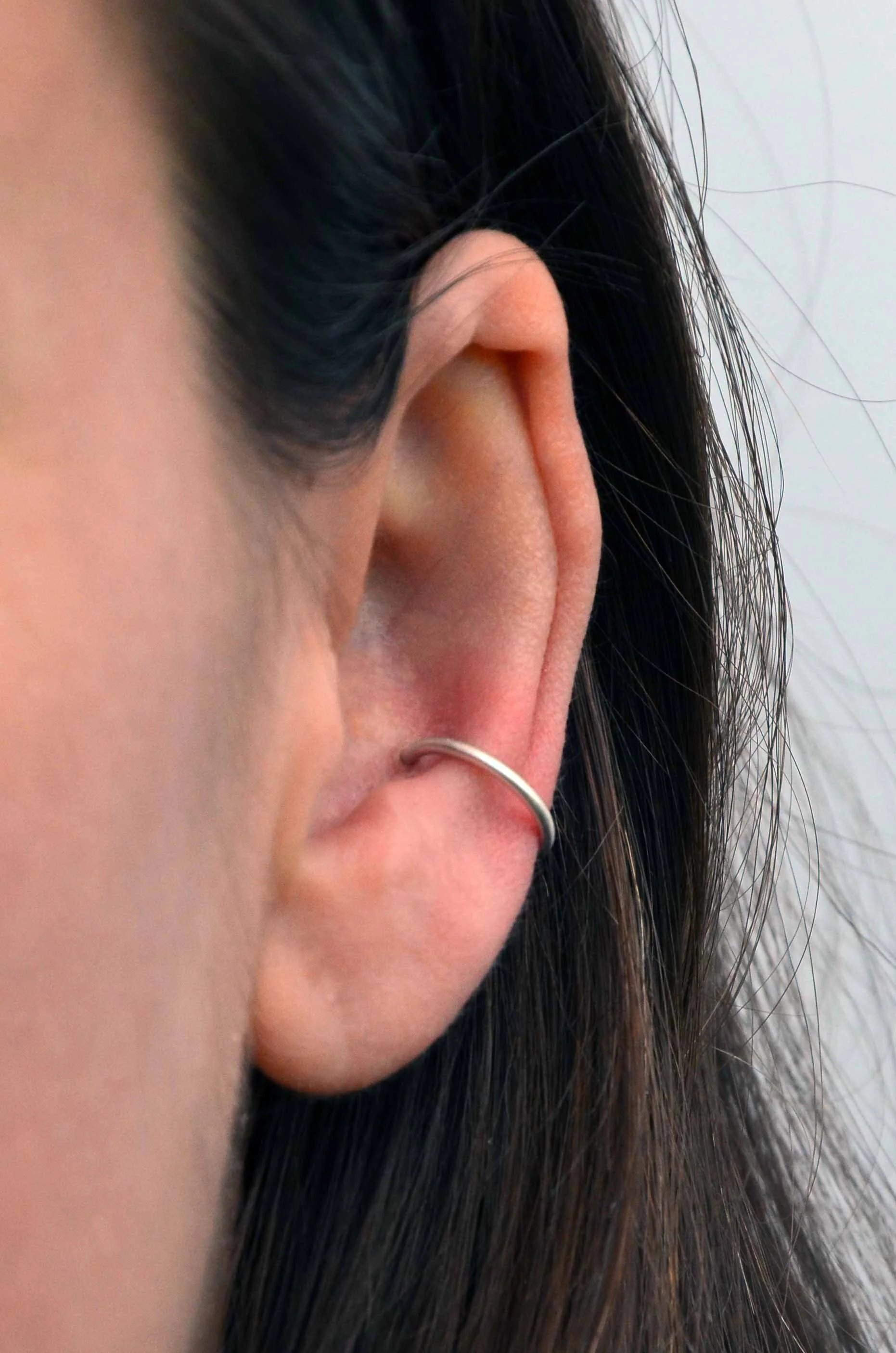 brushed satin sterling silver conch hoop on model