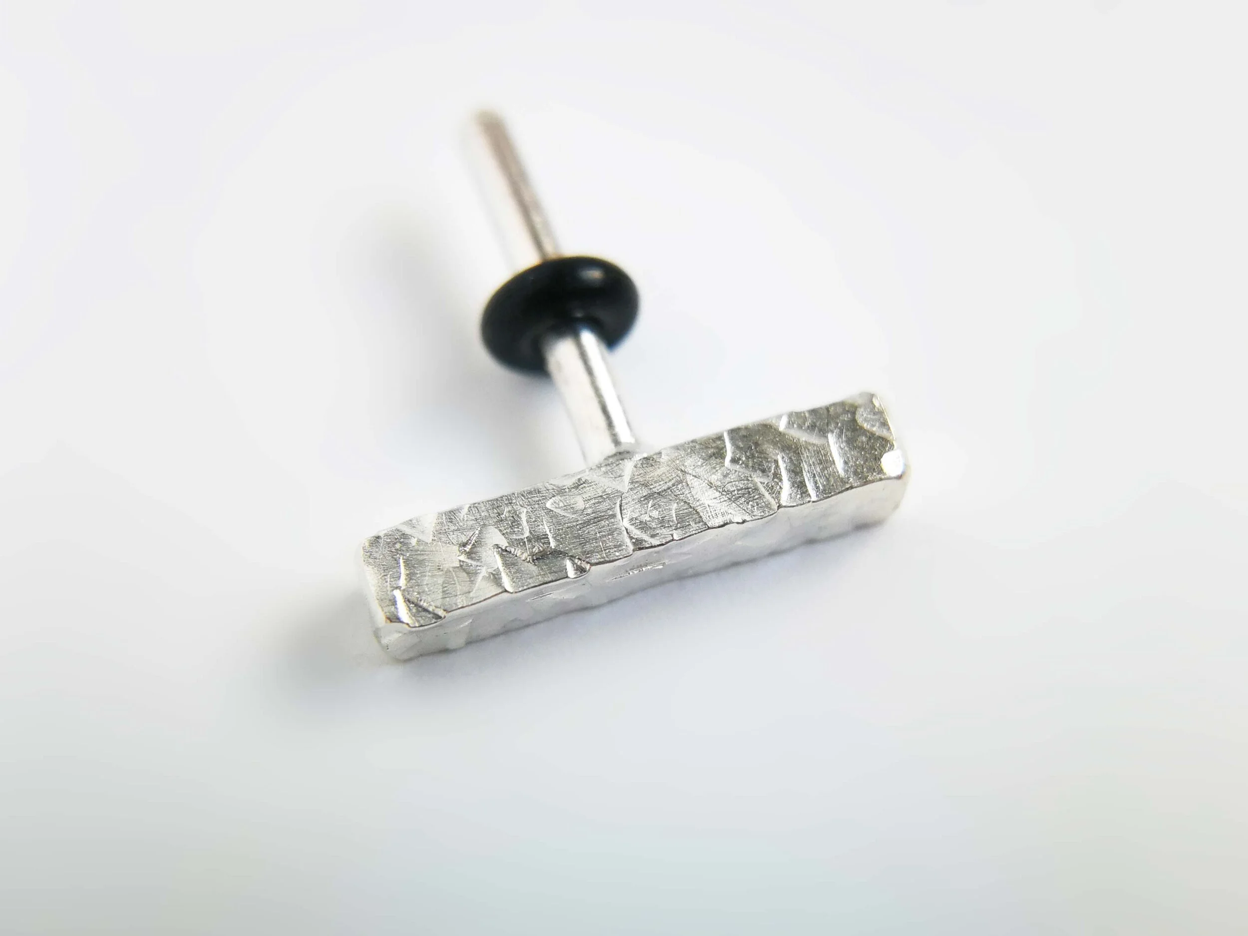 Copy of Textured silver conch earring on white background