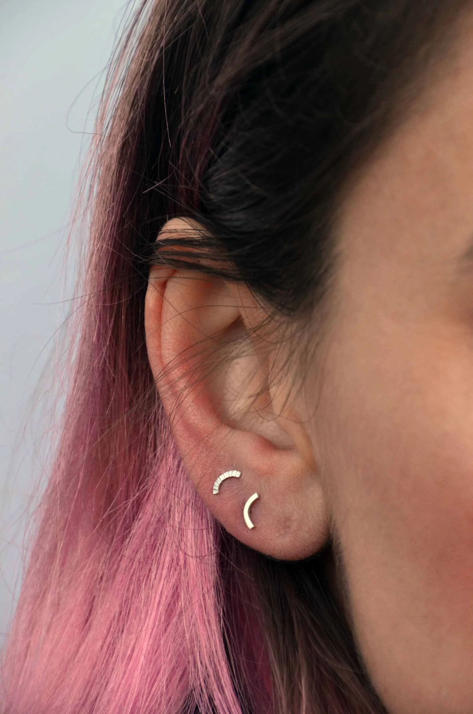 mix and match silver earrings on model