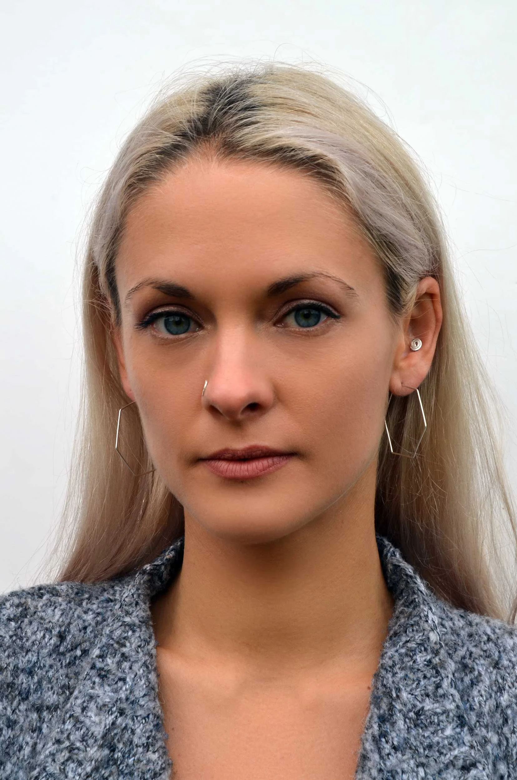 handmade thin silver hexagon hoops on model