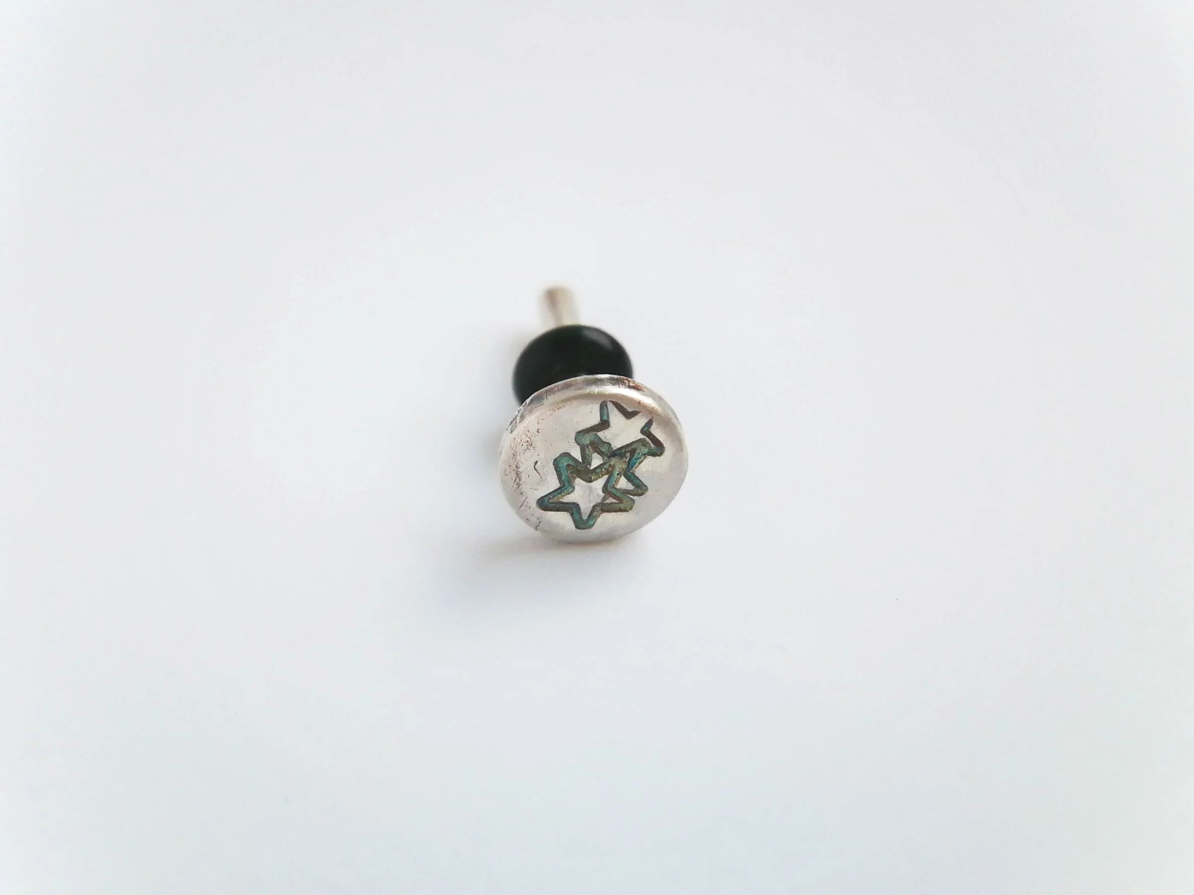 Star stamped conch earring handmade from recycled silver