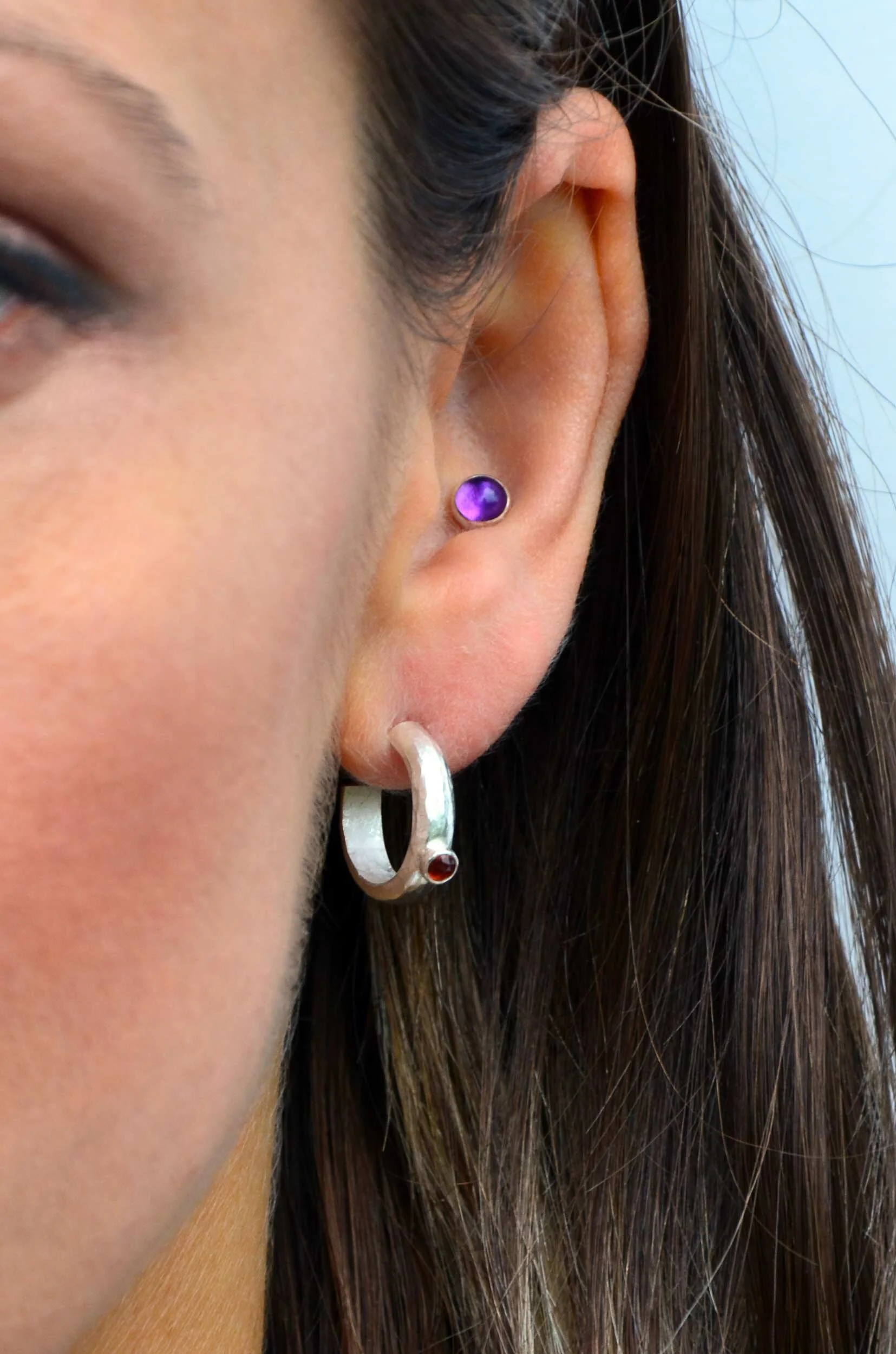 Handmade statement earrings with garnet by victoria grace silversmith on model