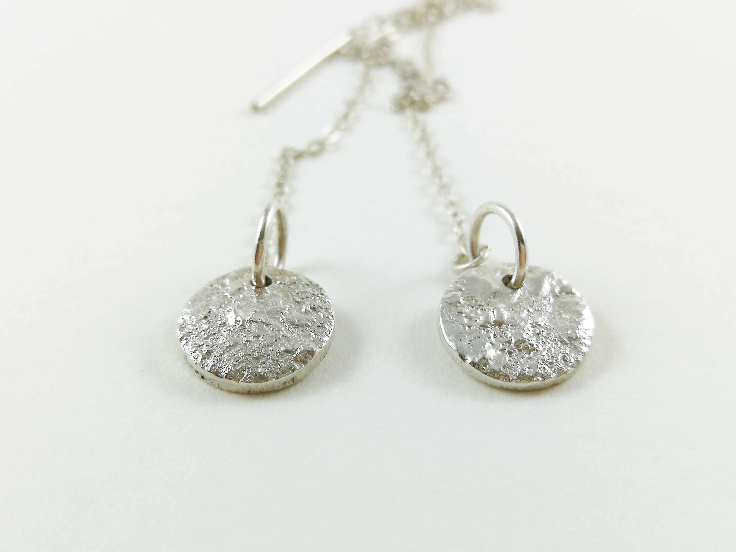 Reticulated silver threader earrings white background