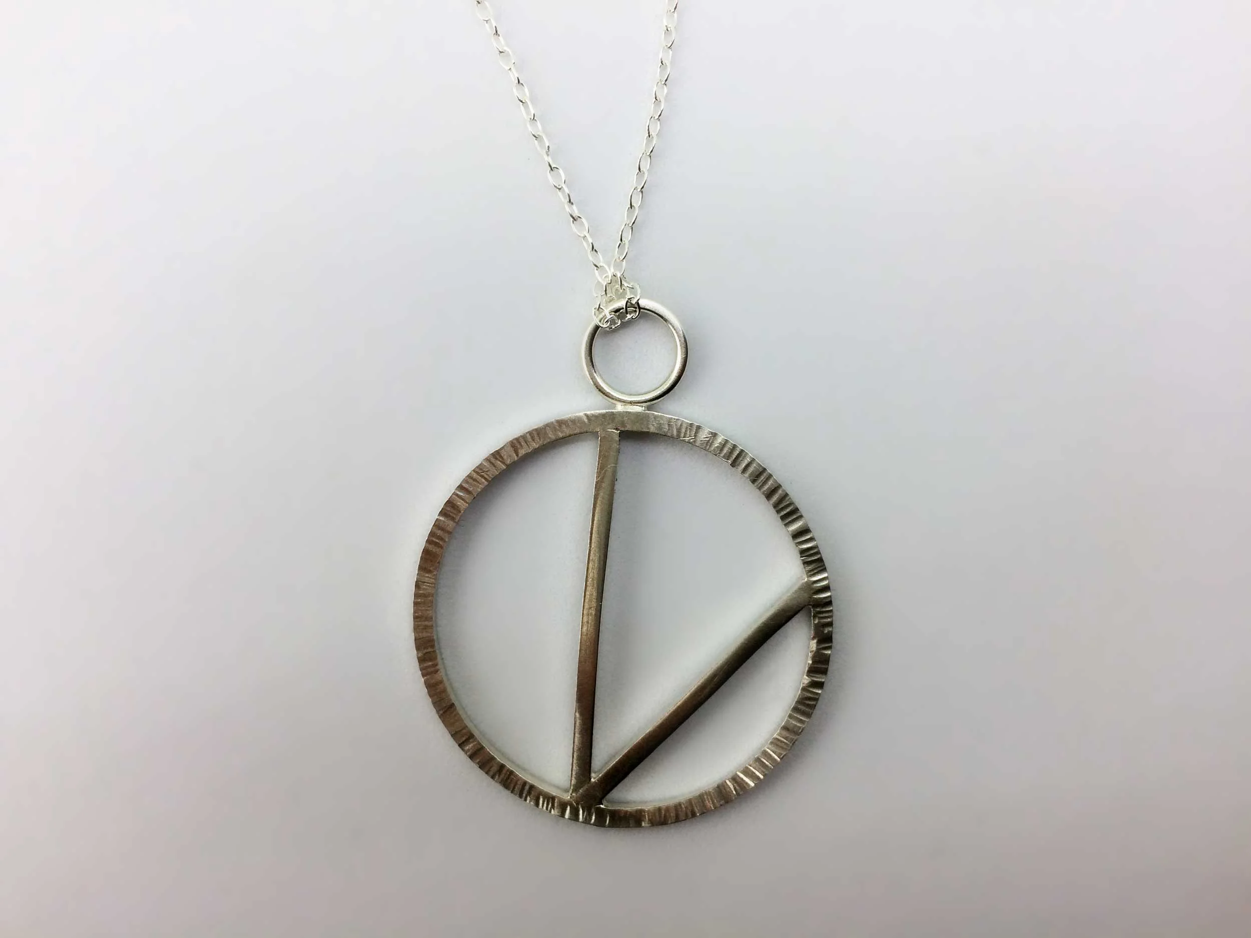 handmade circular vegan pendant on white background victoria grace clothes