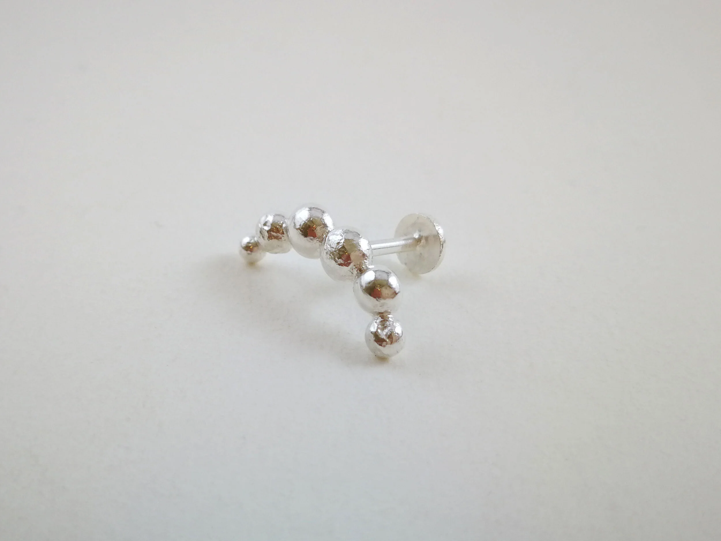 conch-earring-handmade-sculpture-on-white-background.jpg