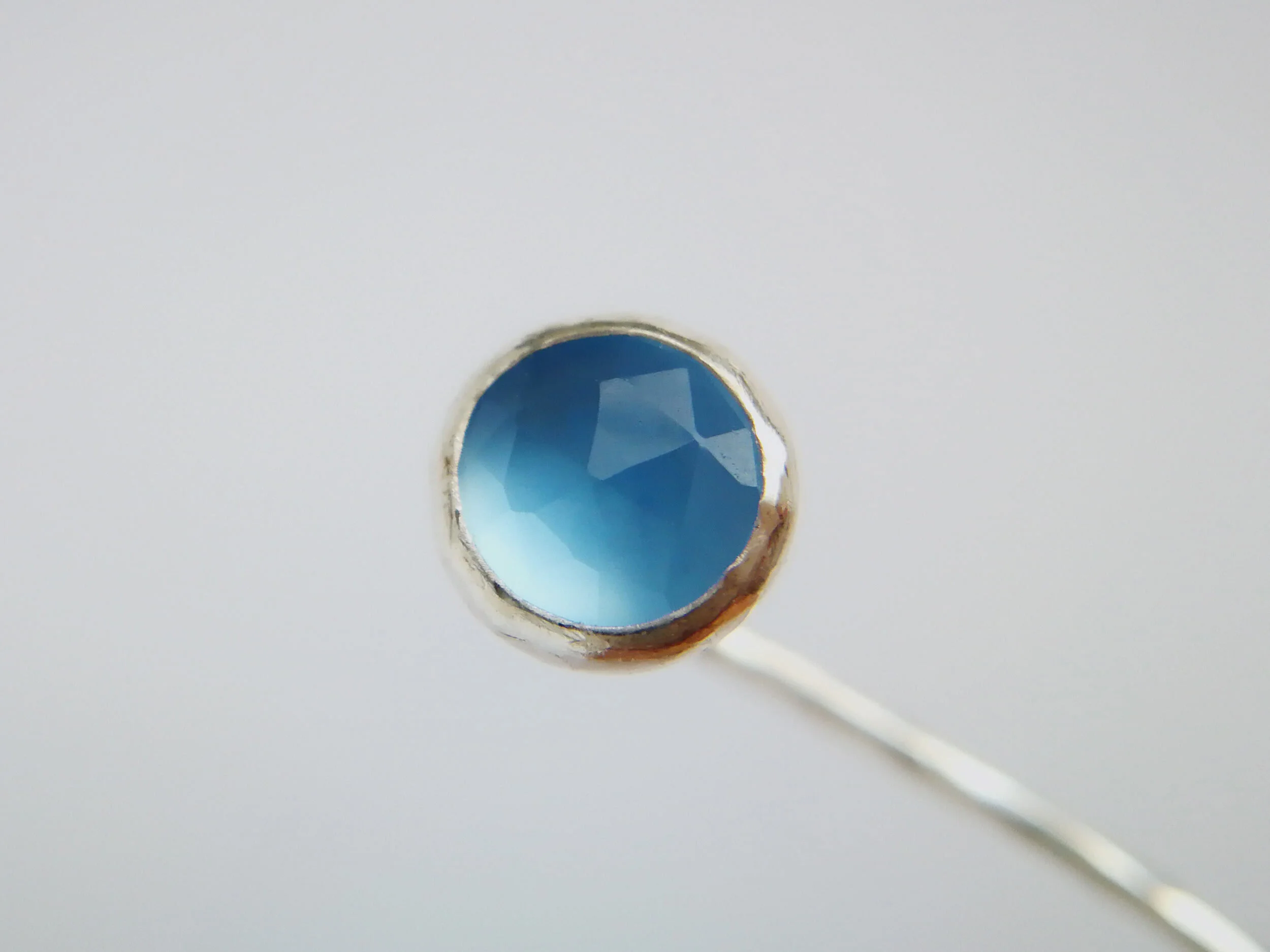 Blue chalcedony faceted gemstone earring close up