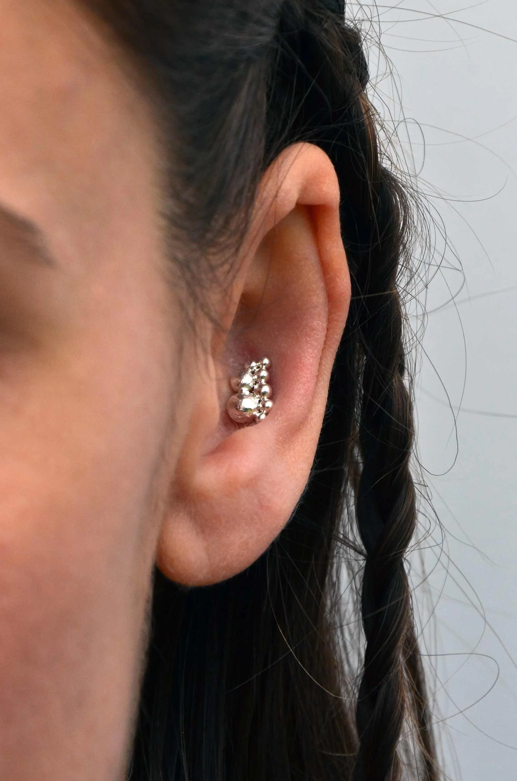 Silver wave conch earring on model handmade victoria grace silversmith