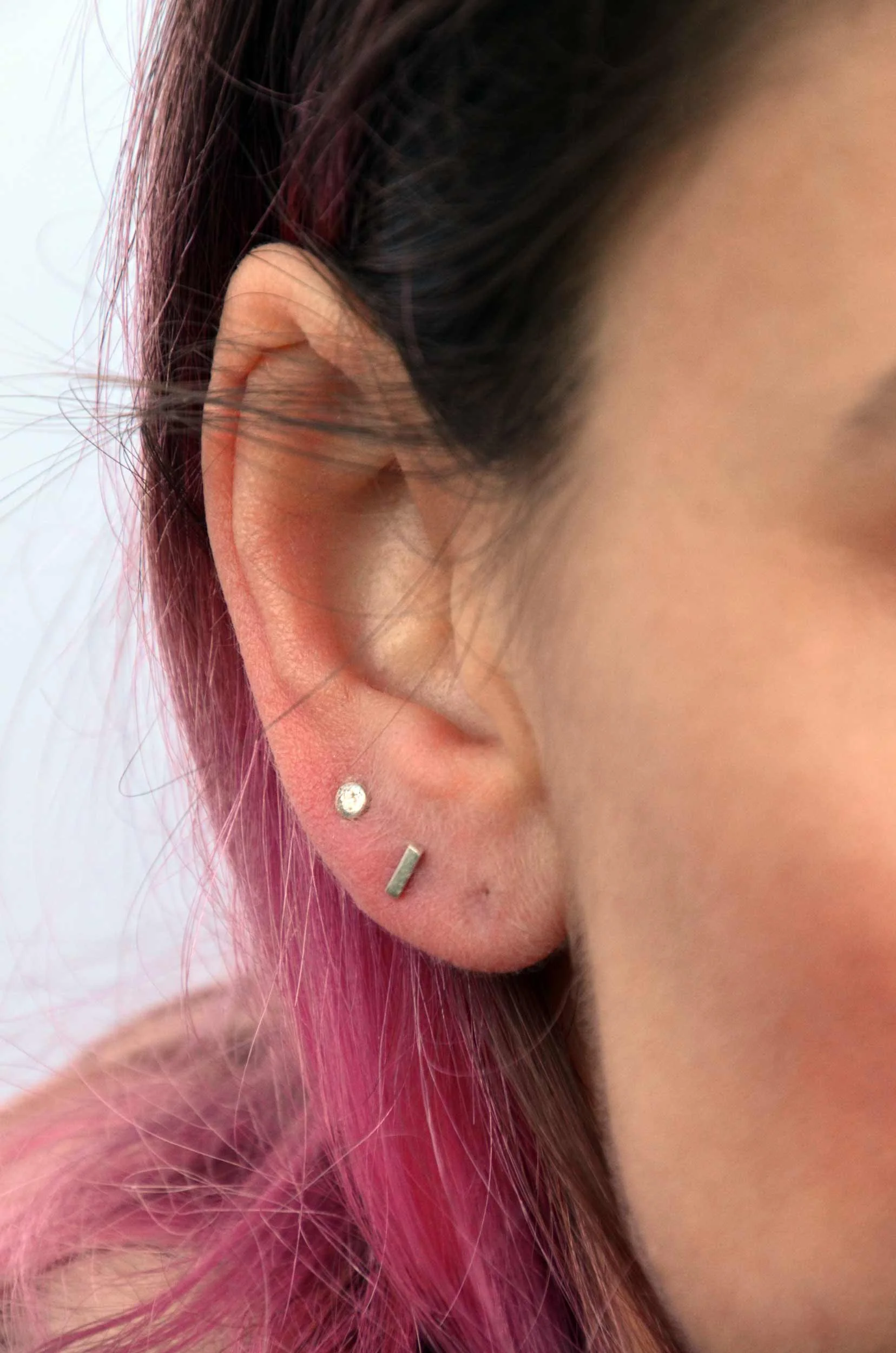 dot and bar stud earrings on model