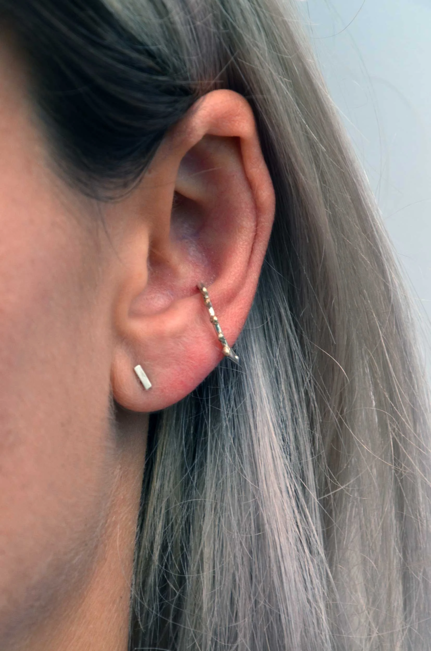 silver and gold conch hoop on model