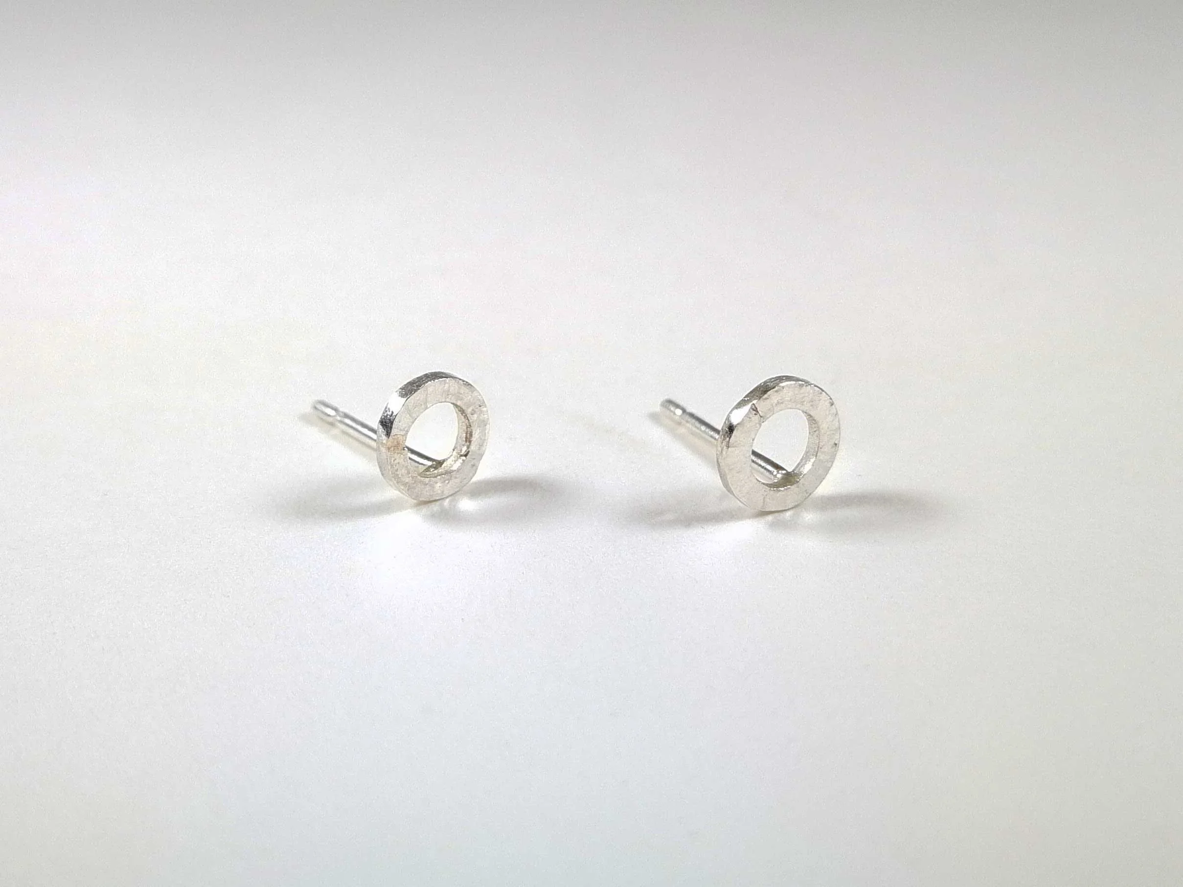 Hammered silver circle studs on white background victoria grace silversmith