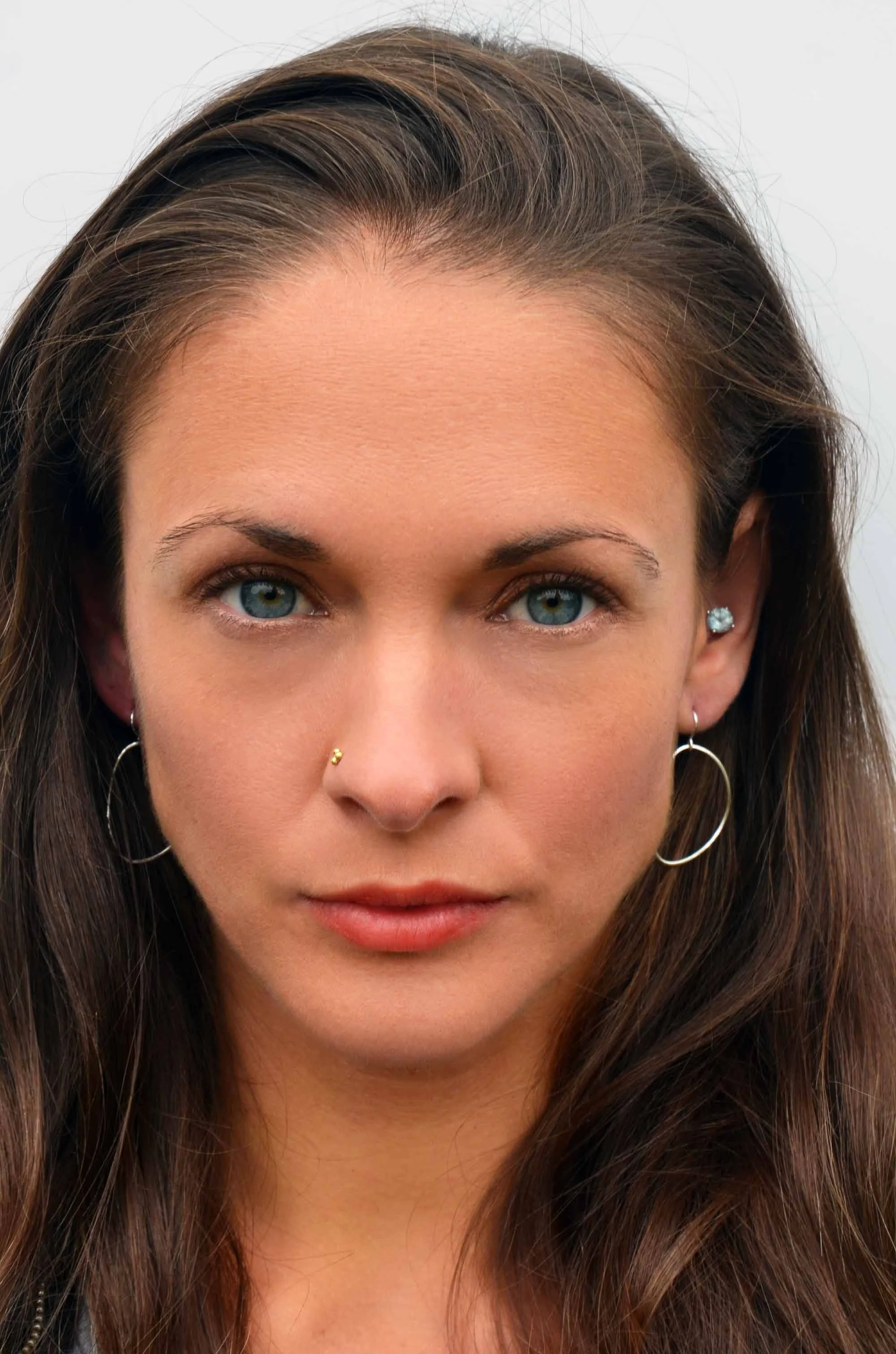 Freeform circle earring medium hoops on model