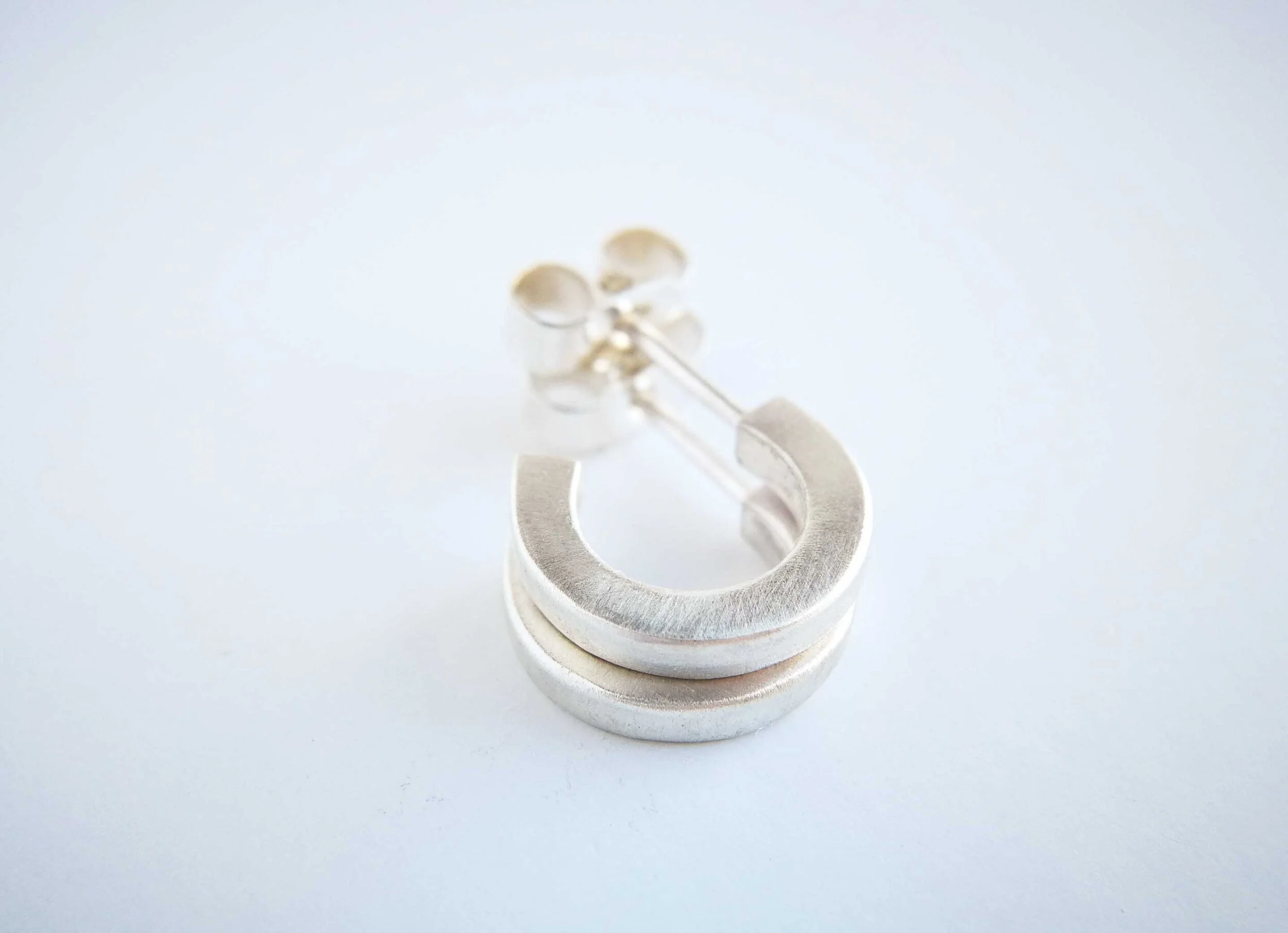 recycled silver tiny hoop earrings white background victoria grace silversmith