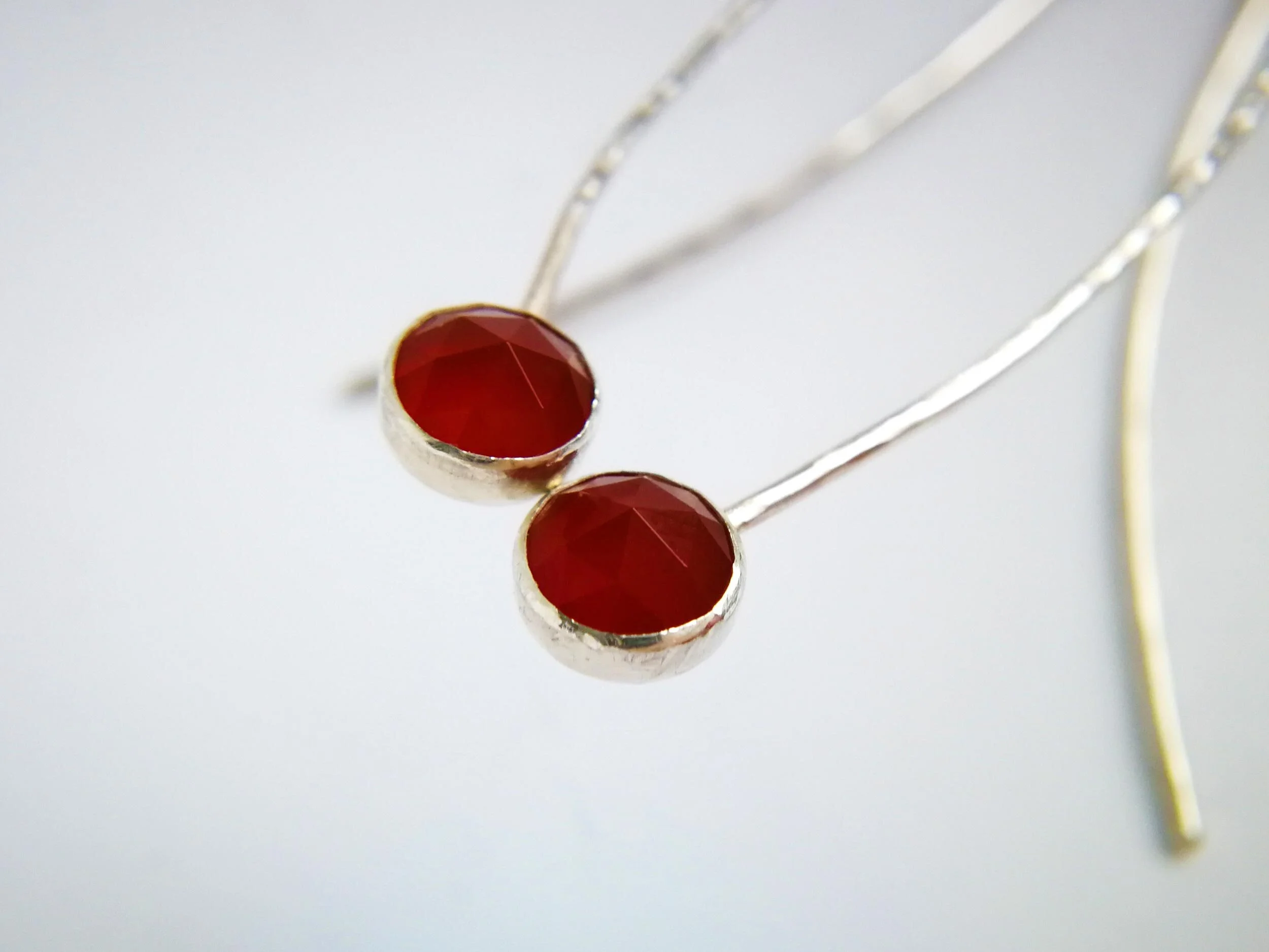 Blood red fecaeted gemstone earrings close up handmade