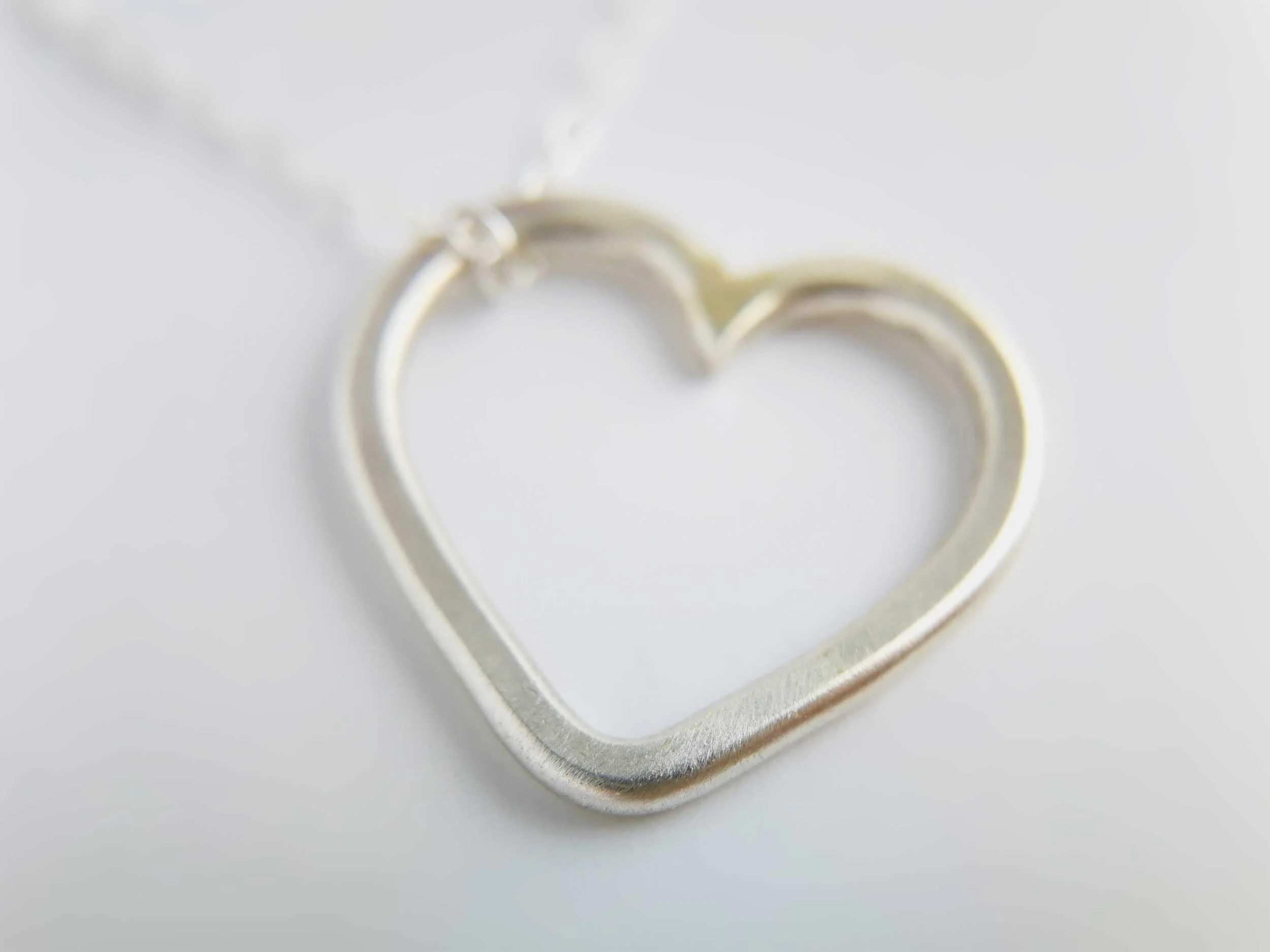 Minimalist heart necklace eco silver white background