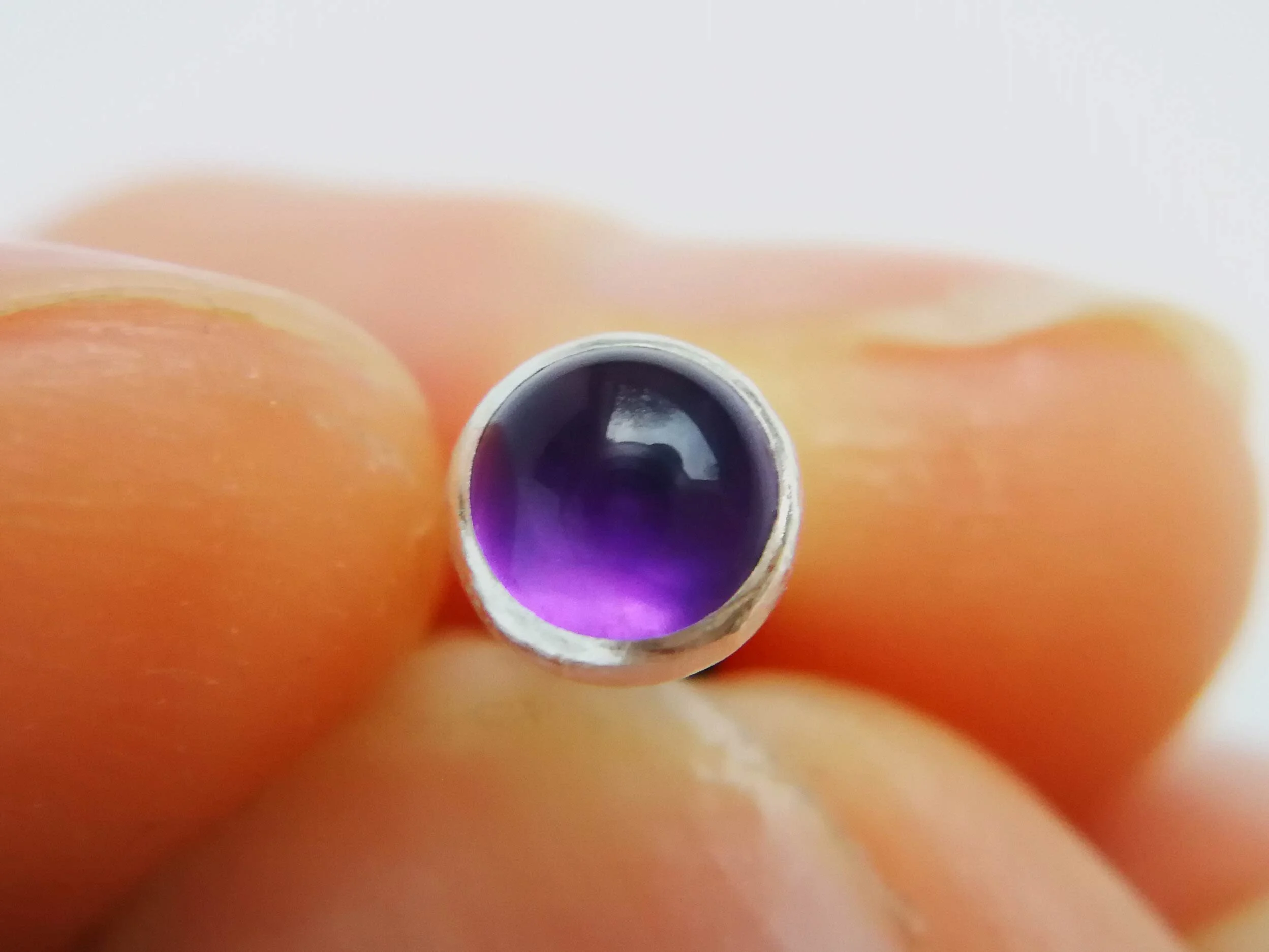 Handmade helix earring with purple amethyst gemstone close up
