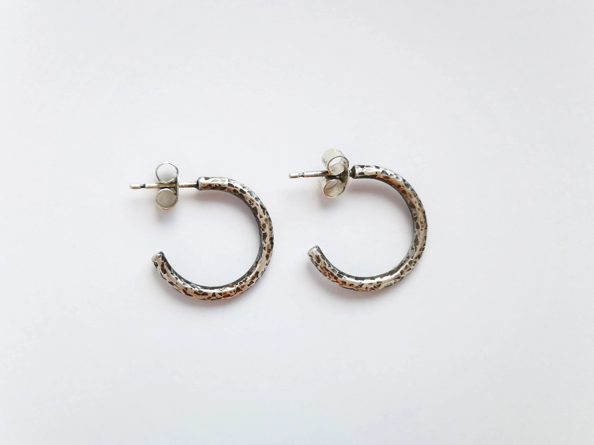Antiqued chunky hoop earrings on white background handmade