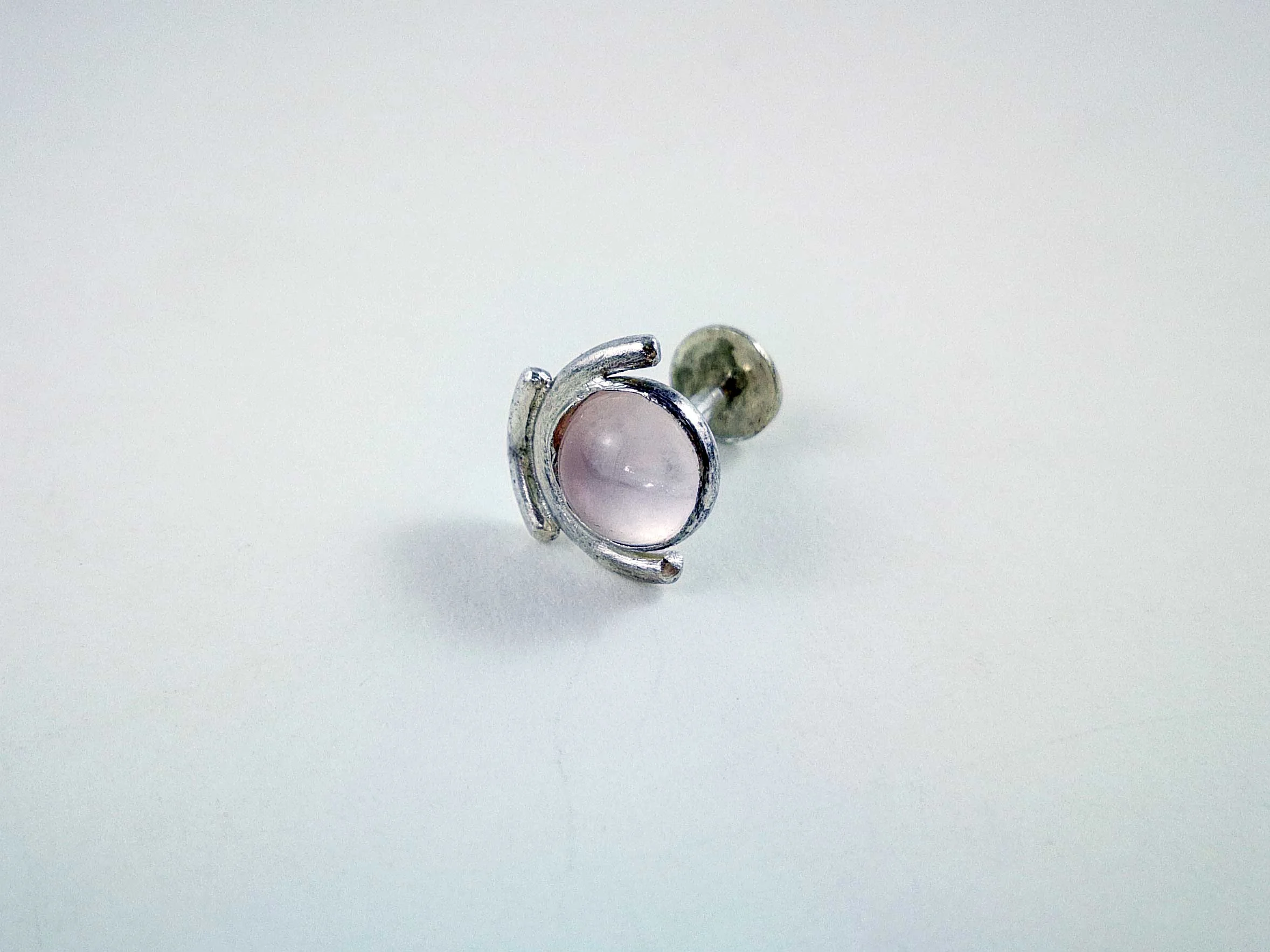 rose quartz conch stud white background