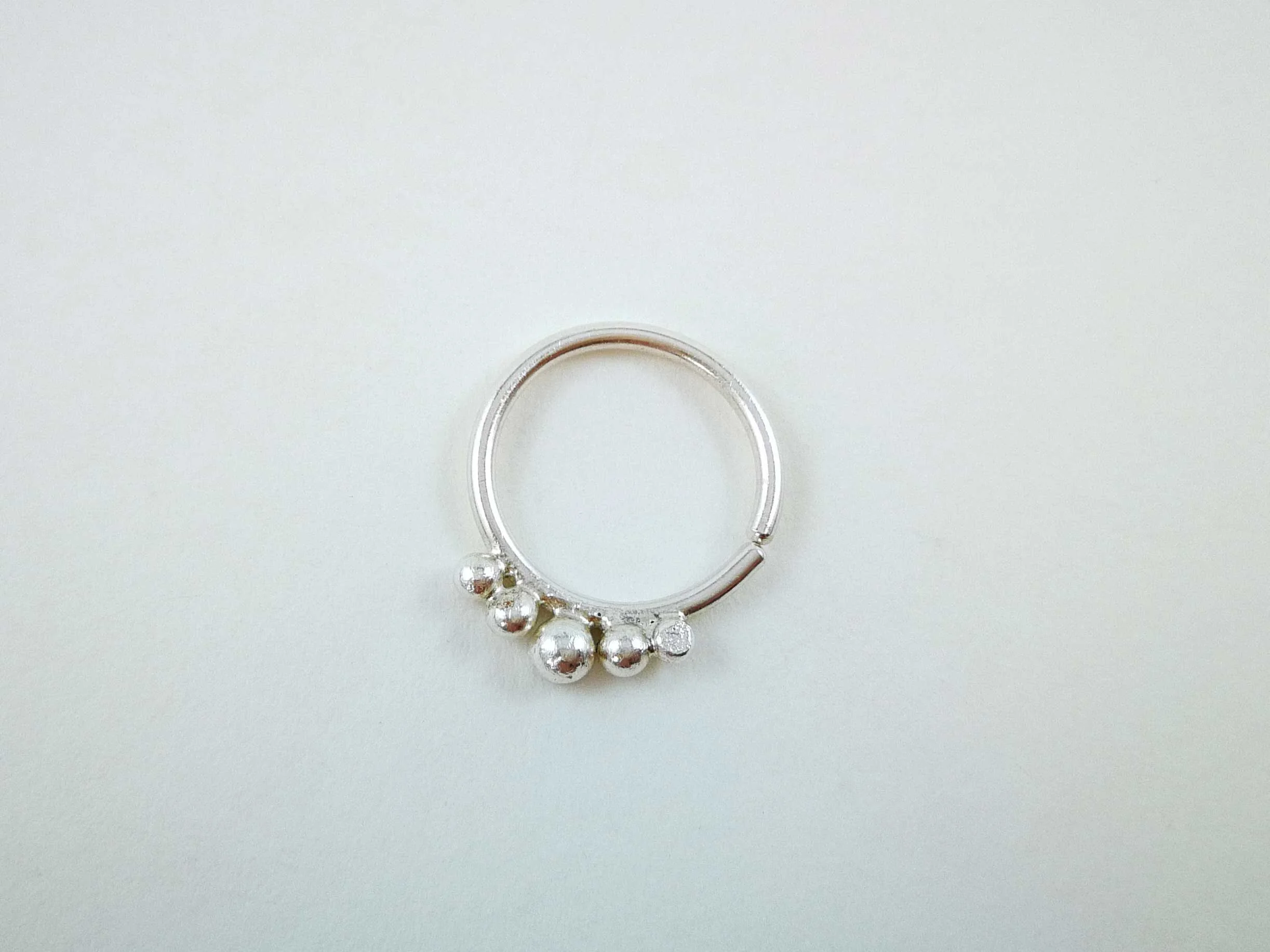 handmade silver conch ring on white background by victoria grace silversmith