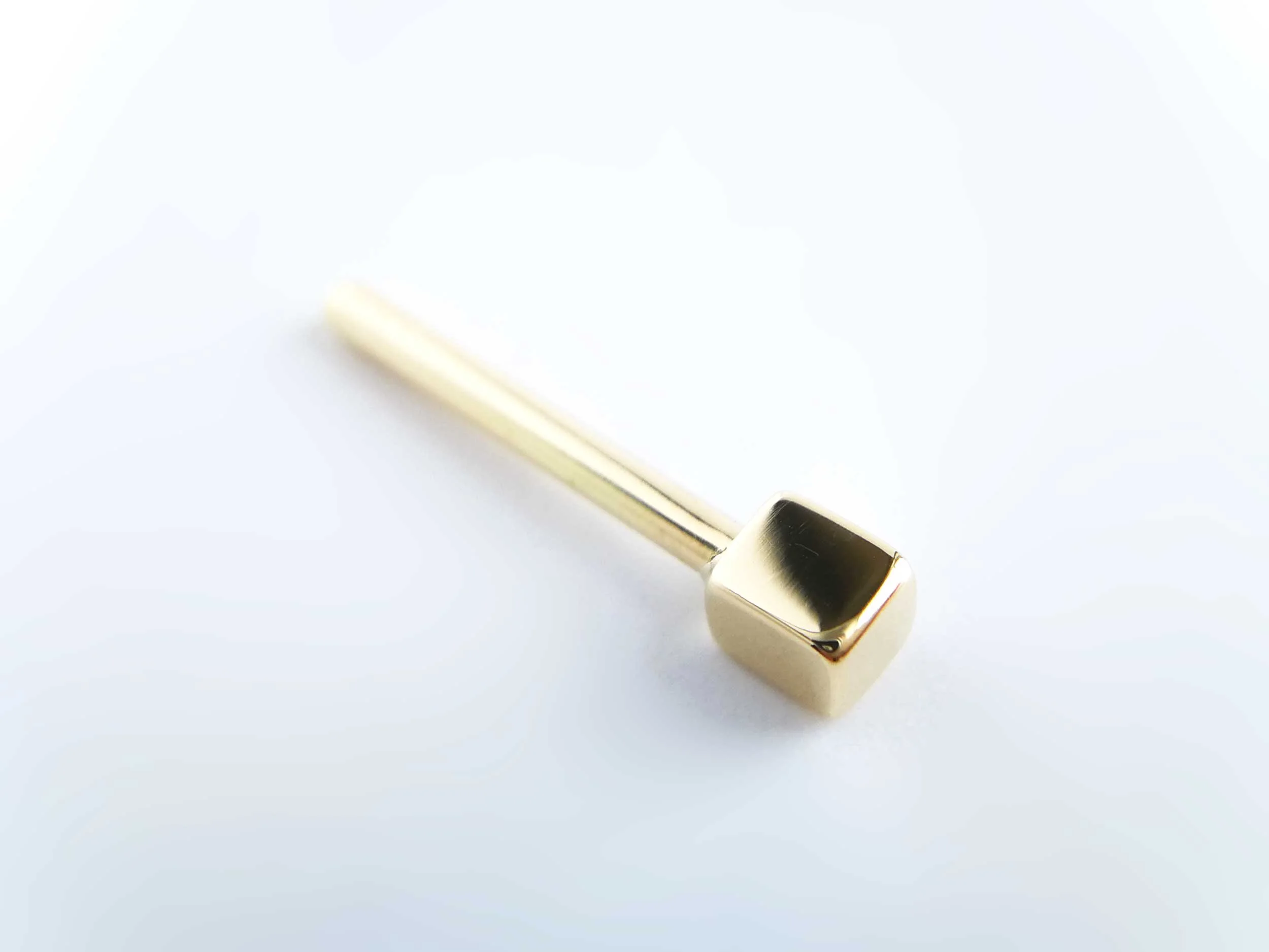 18ct yellow gold piercing earring on white background