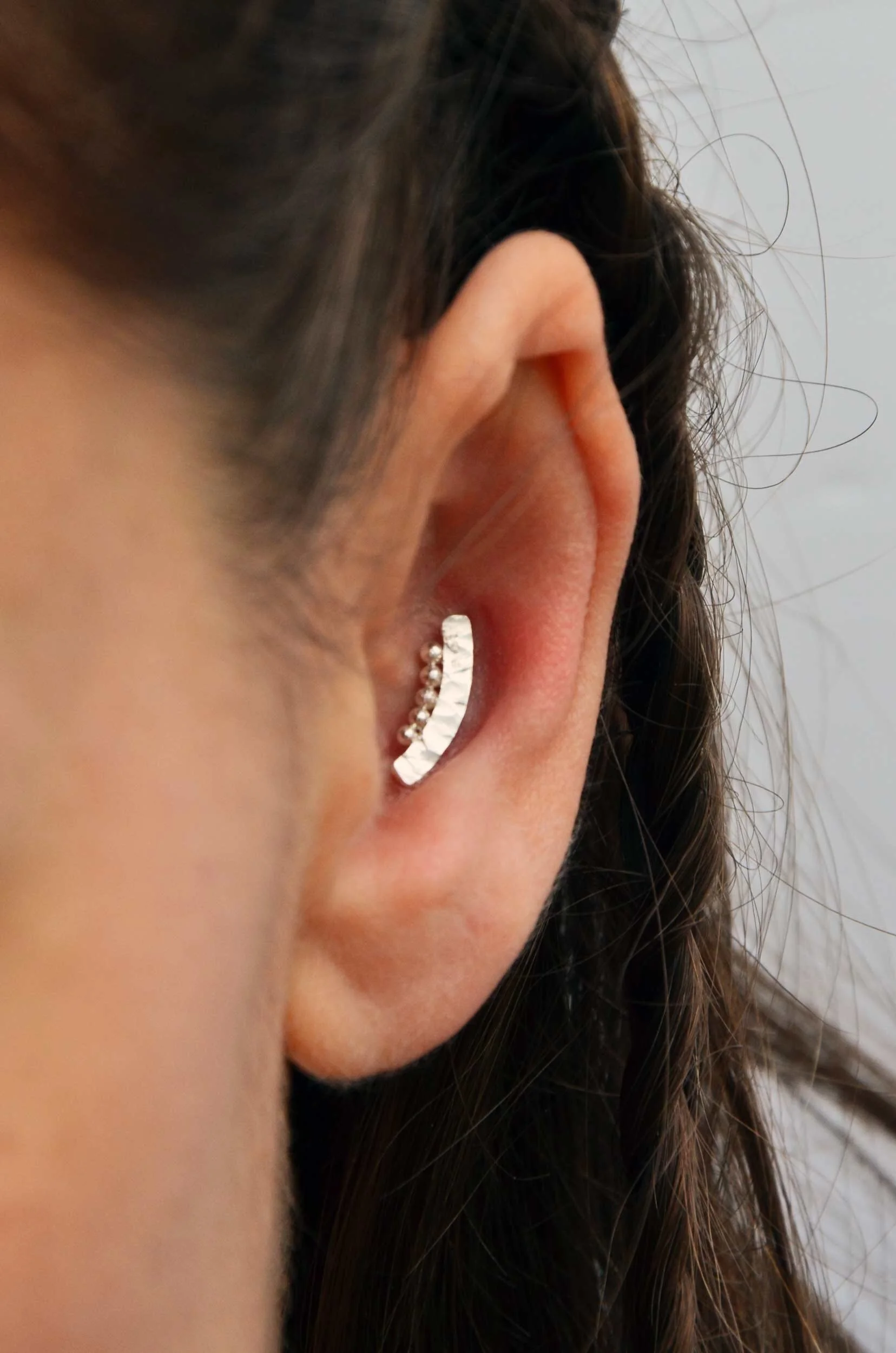 handmade recycled silver conch earring victoria grace silversmith on model