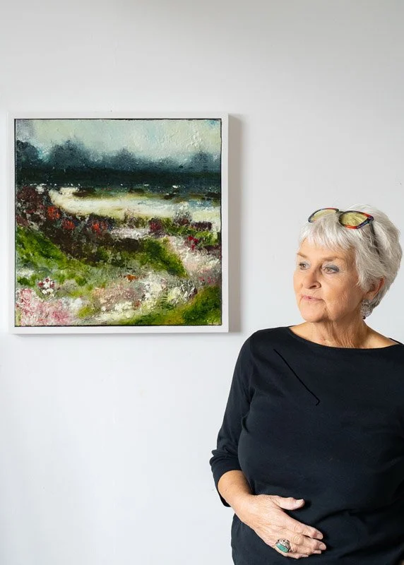 Katrina Solano standing in front of her fine art oil painting