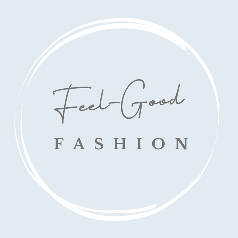A circular badge with a light blue background and black cursive text that reads 'Feel Good' and smaller text below that says 'FASHION'.
