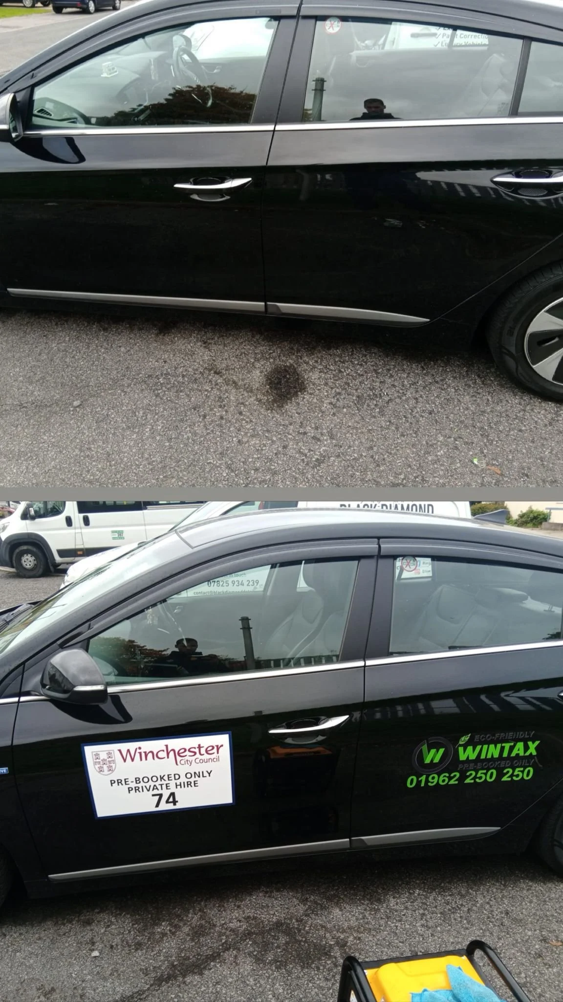 Black car with advertising stickers for Winchester City Council and Wintax on the side, parked on a paved surface with other vehicles in the background.