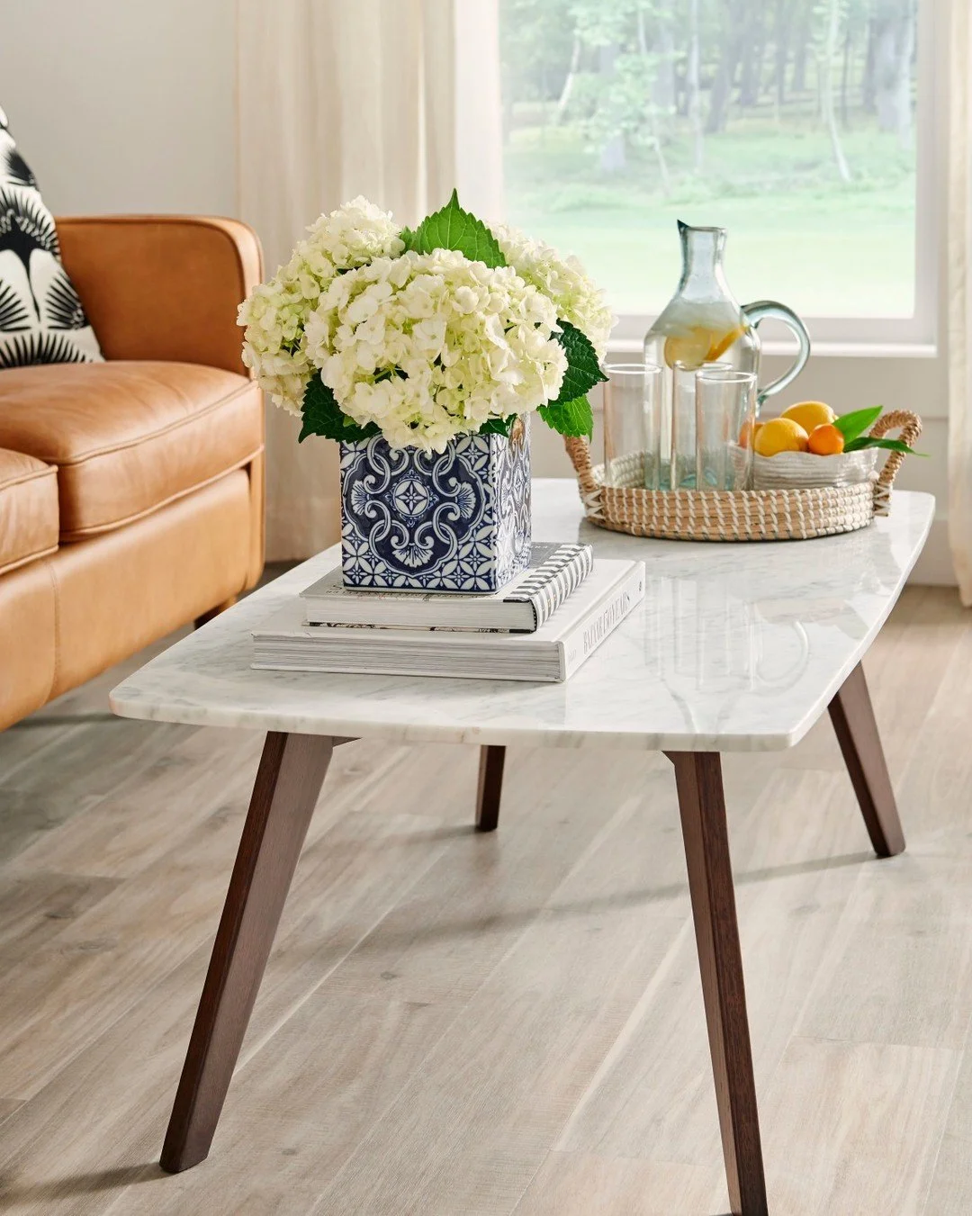 Turn your living room into an exotic getaway with @manningtonfloors ADURA&reg; Luxury Vinyl Plank, Kona. 🌺 Inspired by the natural beauty of Acacia wood, these planks offer a unique visual of subtle spalting, saw marks, and color variations, all wra
