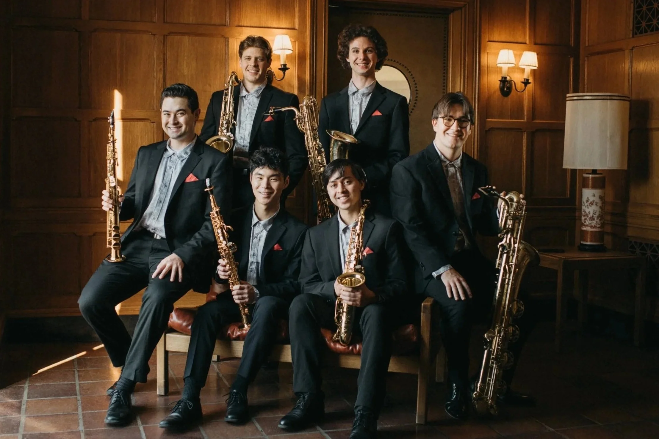 Project Nova, a professional saxophone sextet founded by Landon Chang, posing in a concert hall in Rochester, NY